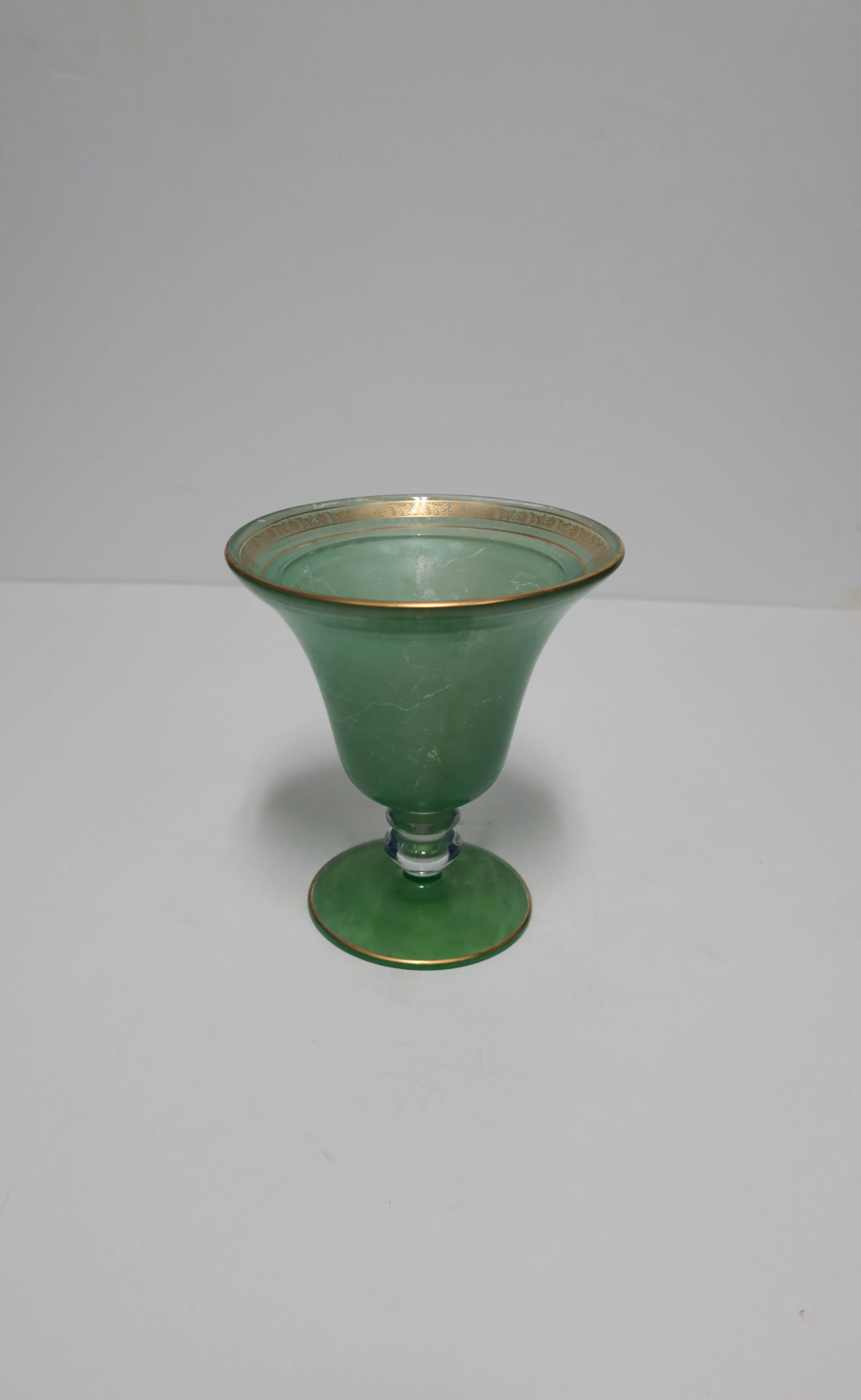 A beautiful early to mid-20th century light green and gold glass urn vase or vessel; piece is finished in a thin green finish, and gold details on the top rim and bottom base. Beautiful standalone piece or with flowers. Measures 6.5