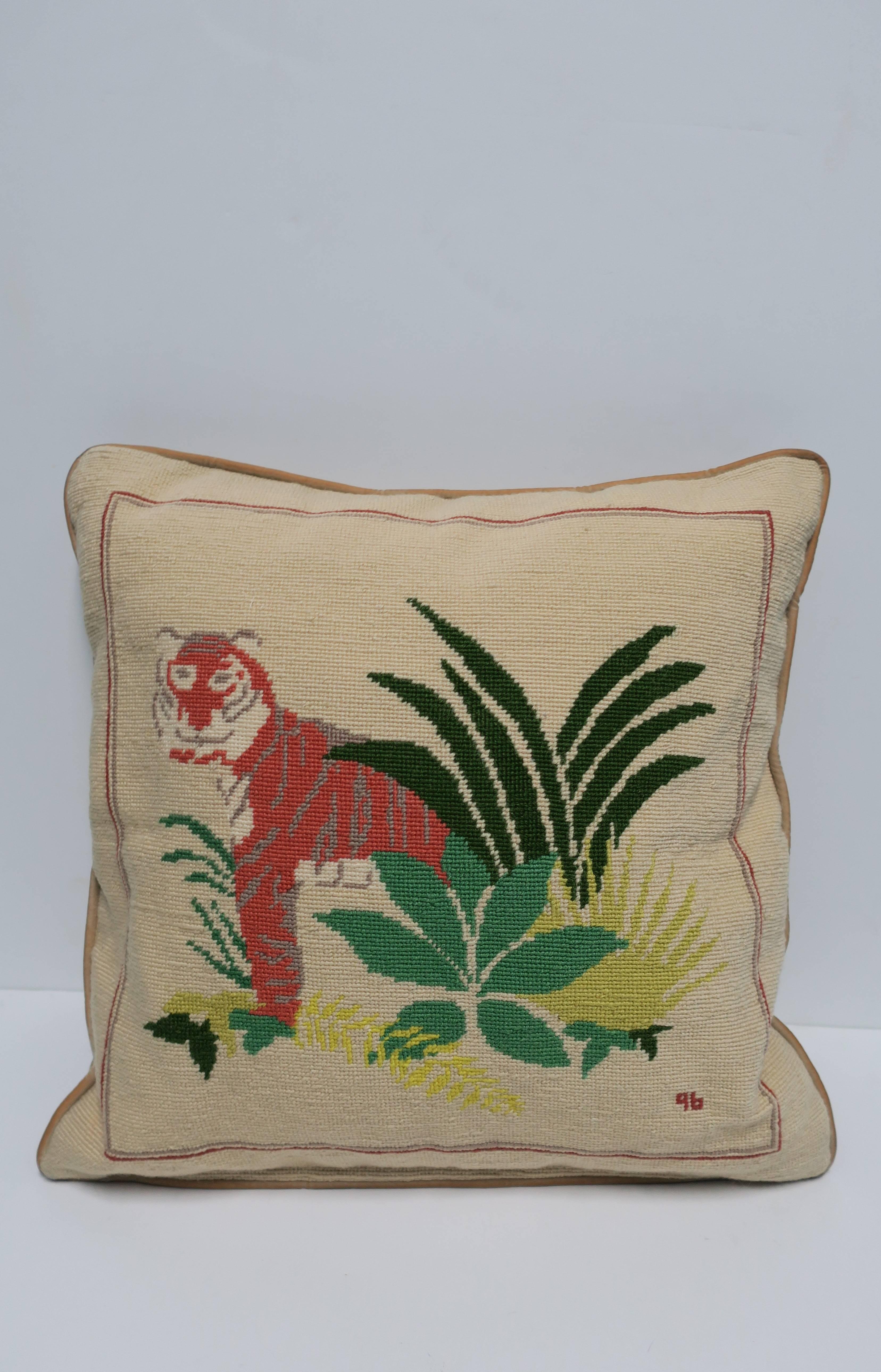 A vintage Art Deco period style needlepoint accent or throw pillow with animal tiger cat and green foliage. Back of pillow is a beige or tan velvet. Pillow features three varying shades of green including 'emerald green', 'Kelly green', and