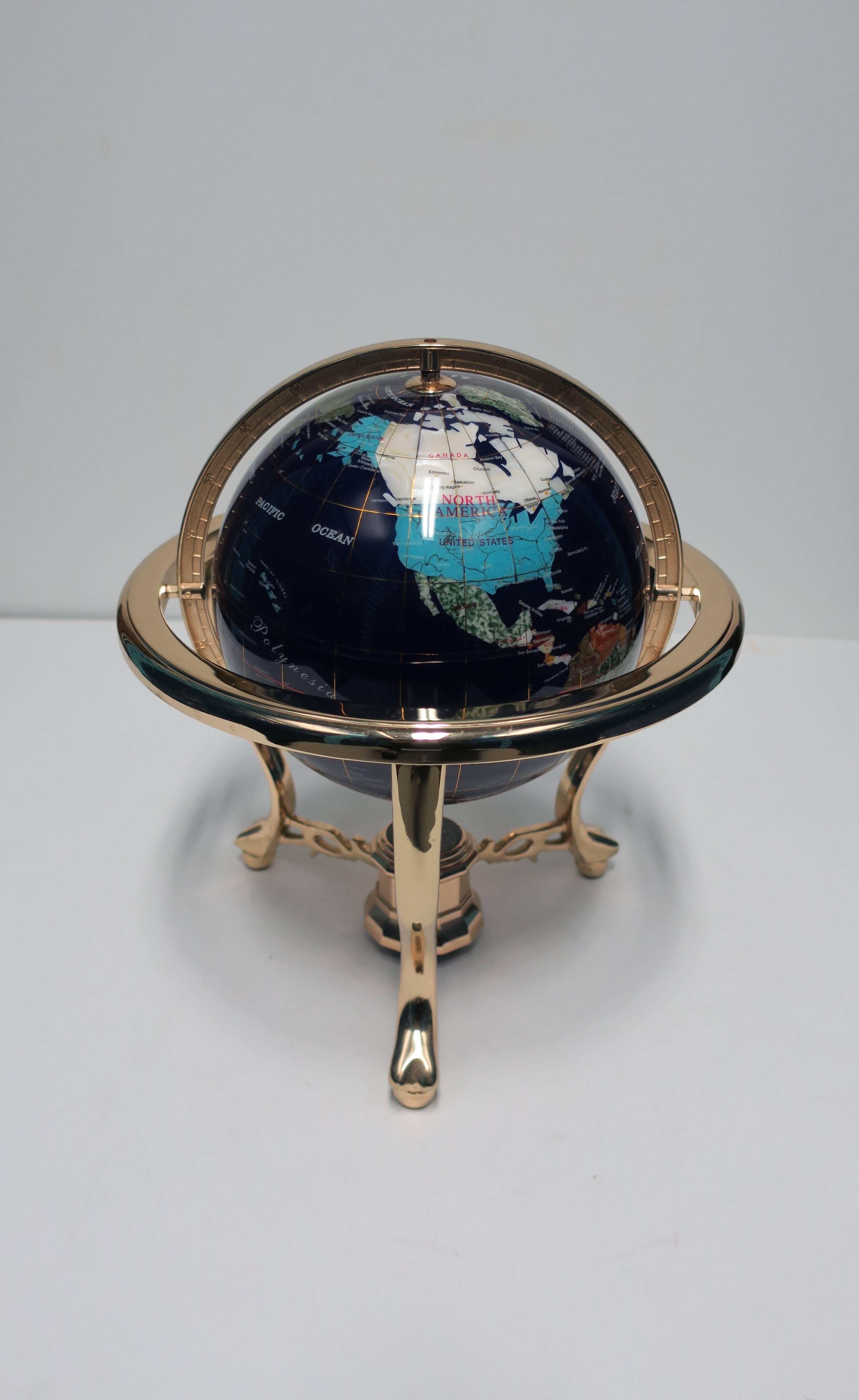 A beautiful vintage world globe comprised of various stones such as marble, mother-of-pearl, onyx, and many others, as show in images. Globe sits in a tripod base and can be spun 360 degrees. 

Measures: 13.5 in. H

Item available here online. By