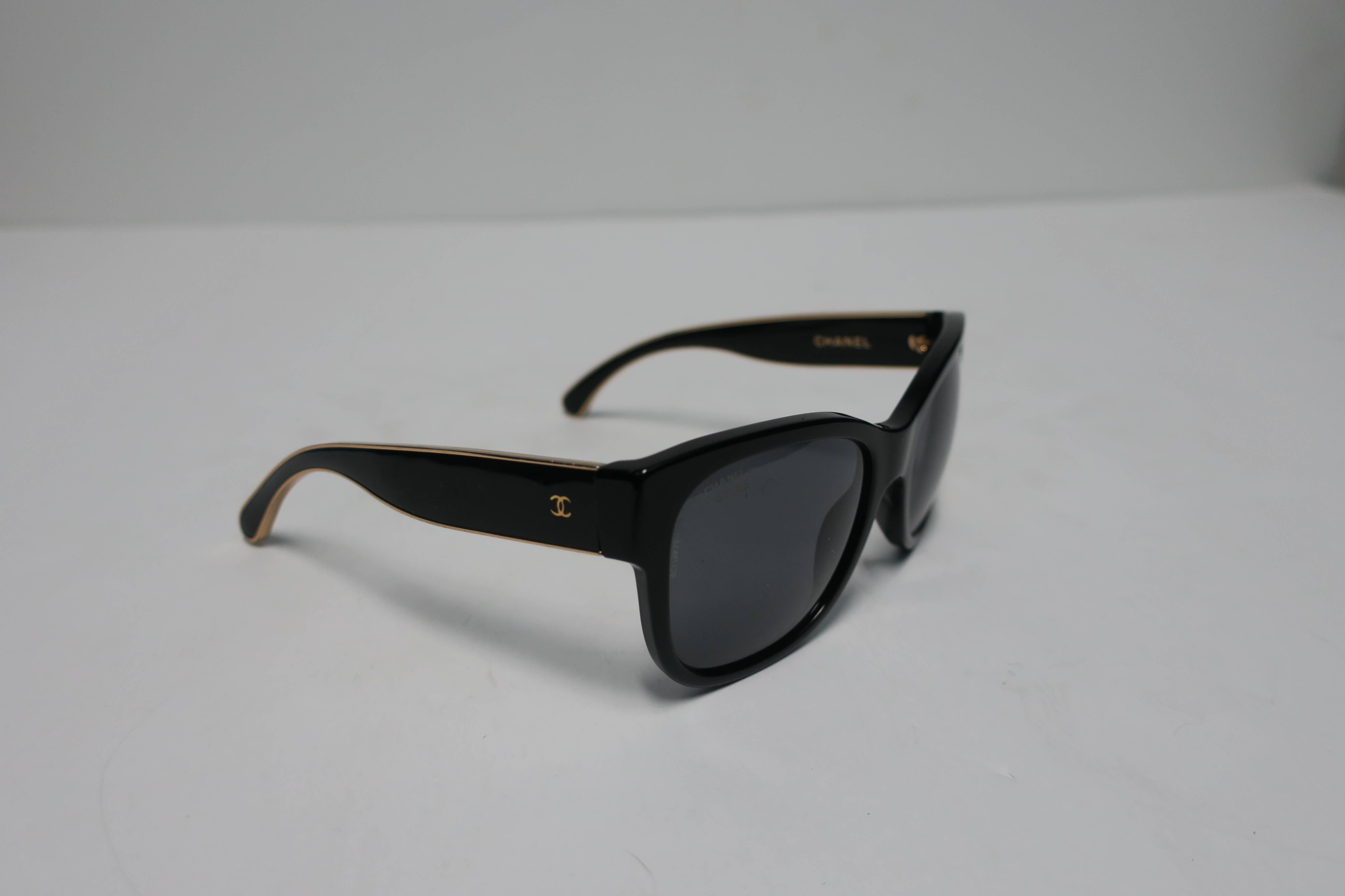 Authentic black and gold CHANEL sunglasses with polarized lenses. Black and gold frame with double “CC” on each side. Marked Chanel on inside frame and on front lens. With original box, hard case, protective cover, booklet, and  authenticity card,