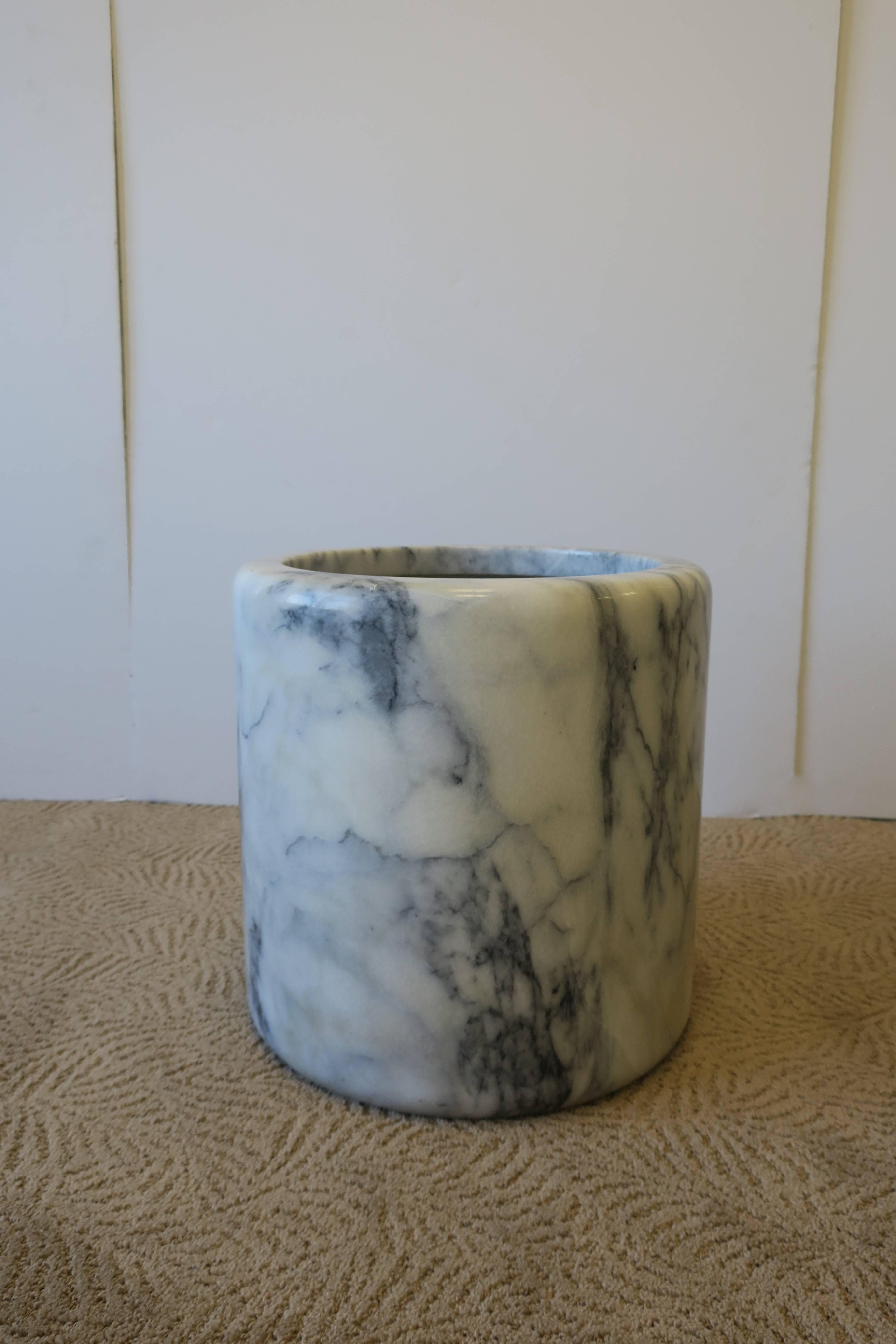 A substantial large minimalist marble vessel, cachepot (plant pot holder) or umbrella stand or holder. Marble is predominantly white with very dark blue or black veining. Marble is polished smooth with smooth rounded edge. Measurements include: