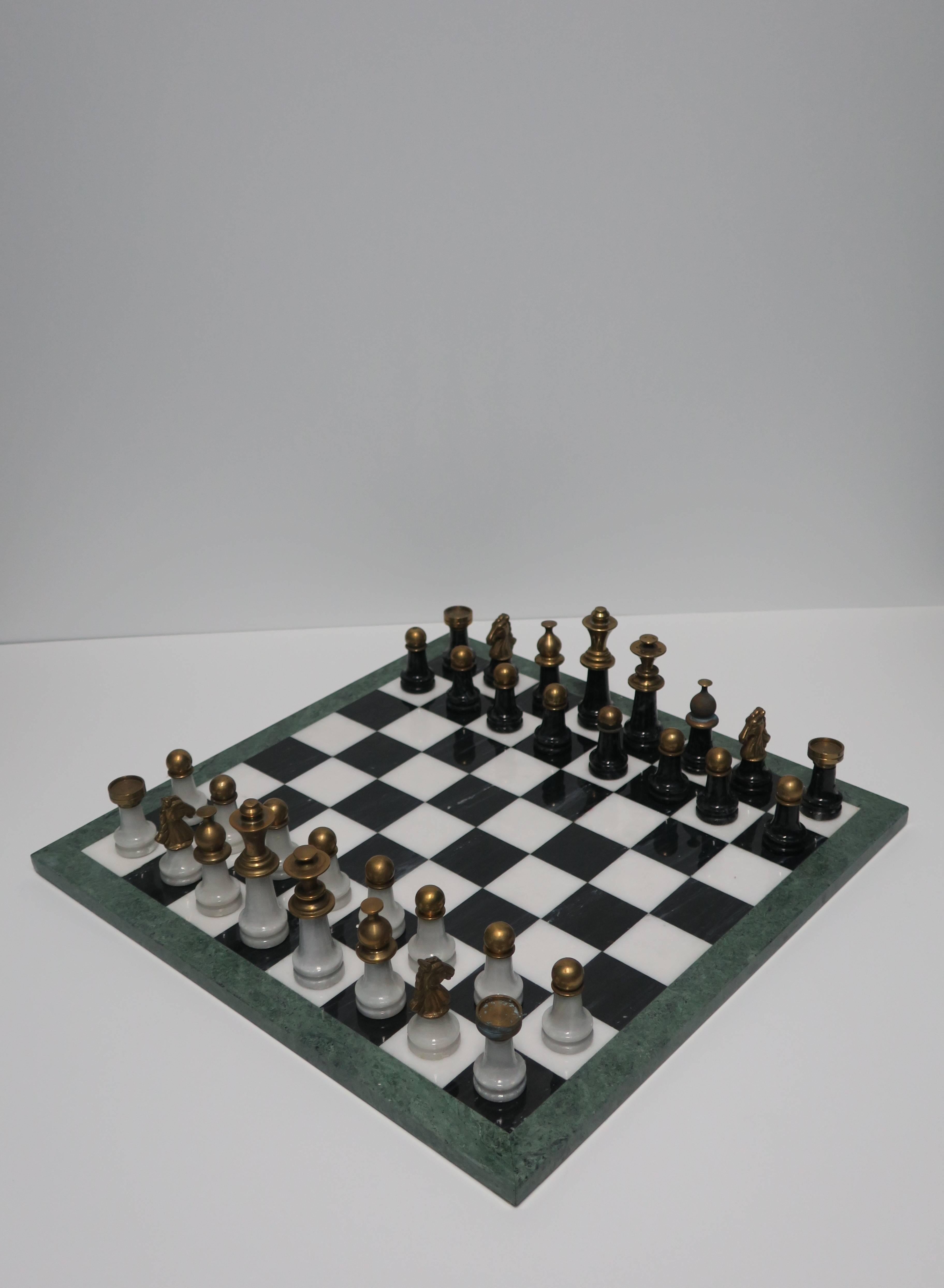 A gorgeous and substantial vintage Modern Italian black, white, and green marble with brass, chess game set. Italy, circa 1970s. Board is black and white marble with a green marble trim. Chess pieces are black marble with brass, and white marble