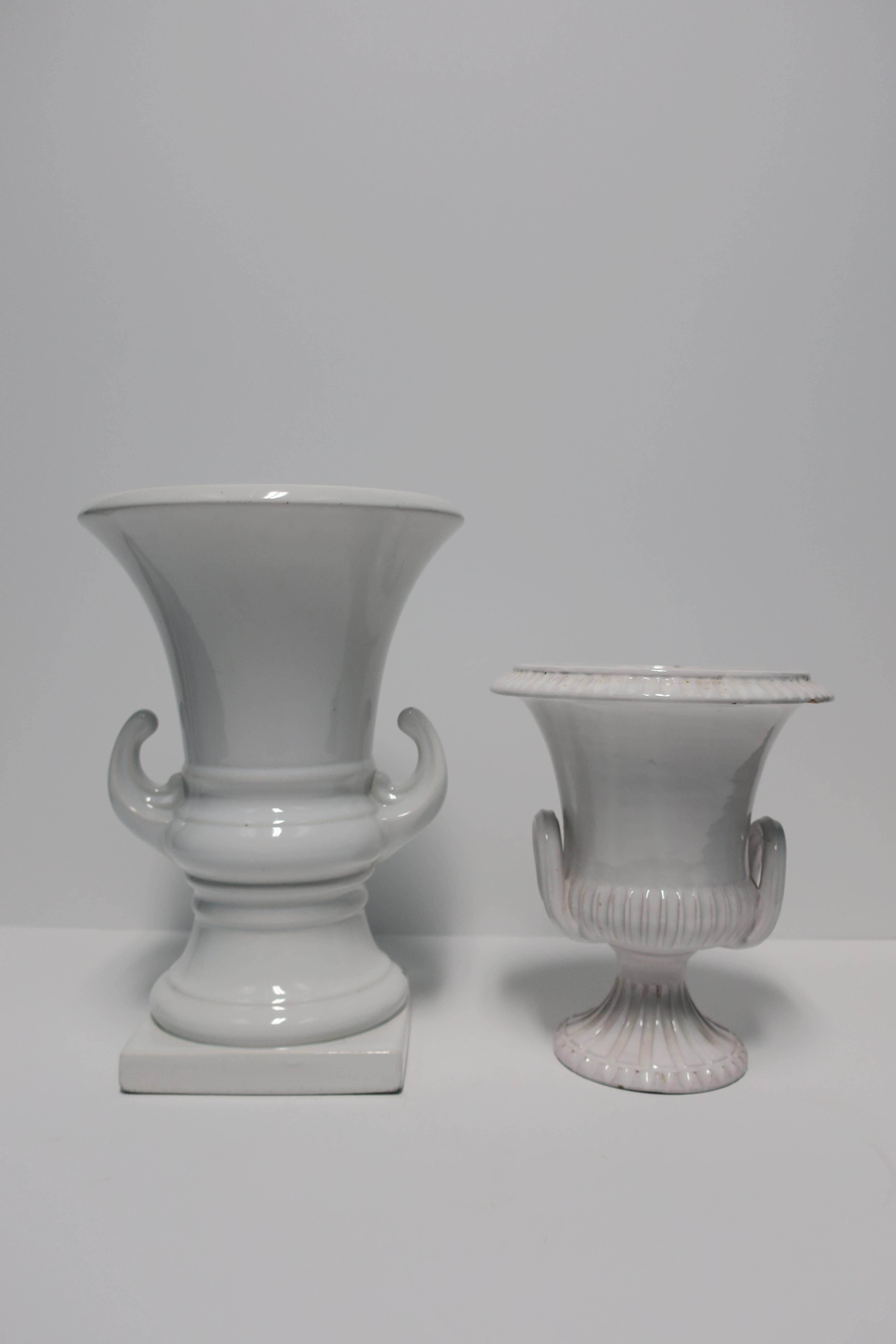 A vintage pair/set of classic Italian white pottery urns vessels or vases, circa late-20th century, Italy. Both are marked 'Made in Italy' on bottom as show in images #9 and 10. Great as standalone pieces or with flowers. 

Measurements:
Large: 12