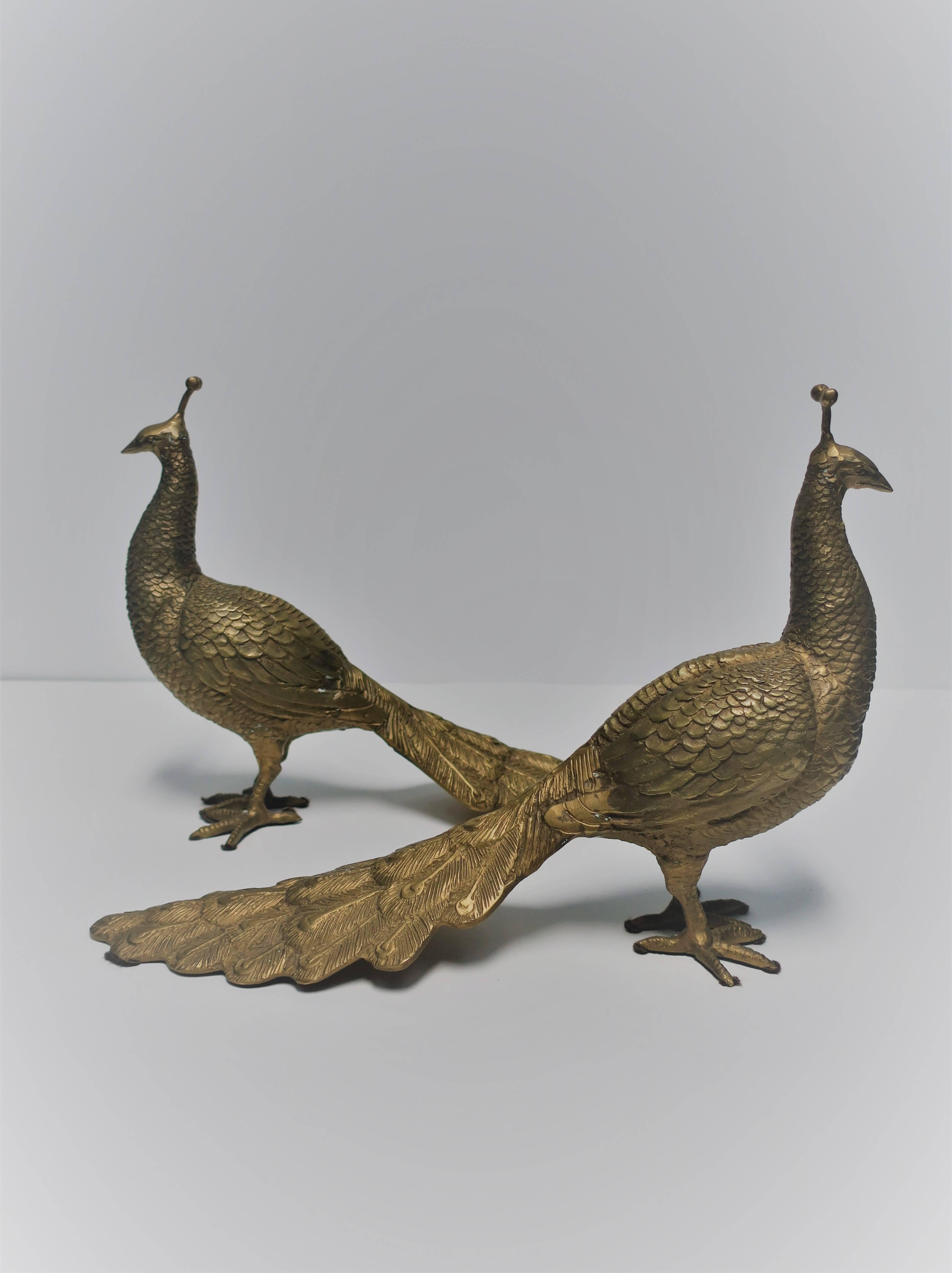 A beautiful and substantial pair of vintage brass Peacock bird sculptures, circa 1960s. Birds measure 10 1/2 inches high, and almost 16 inches long. Pair available here online. By request, pair can be made available by appointment to the trade in