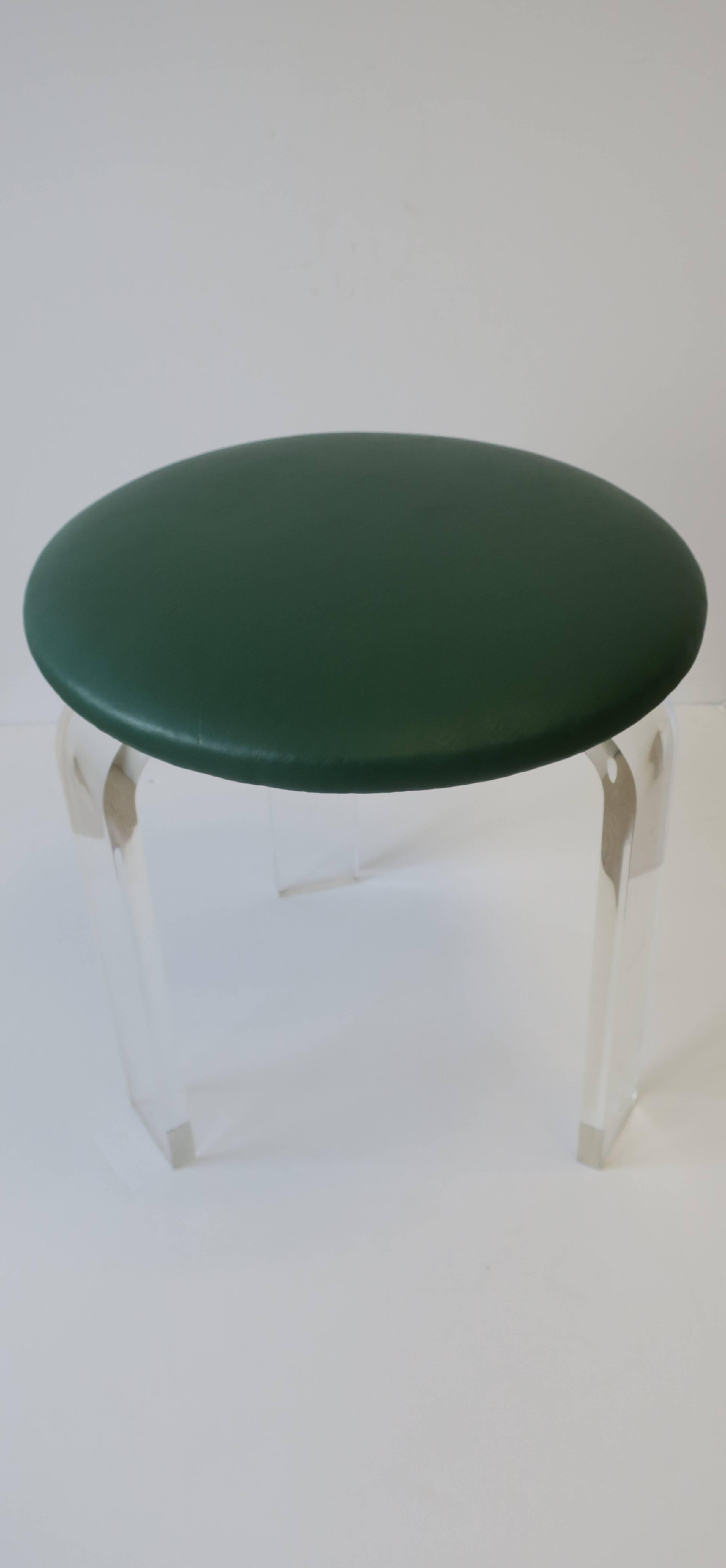 A Modern style Lucite stool or vanity chair with a 'Kelly' green faux leather upholstered seat cushion. 

Measures 16