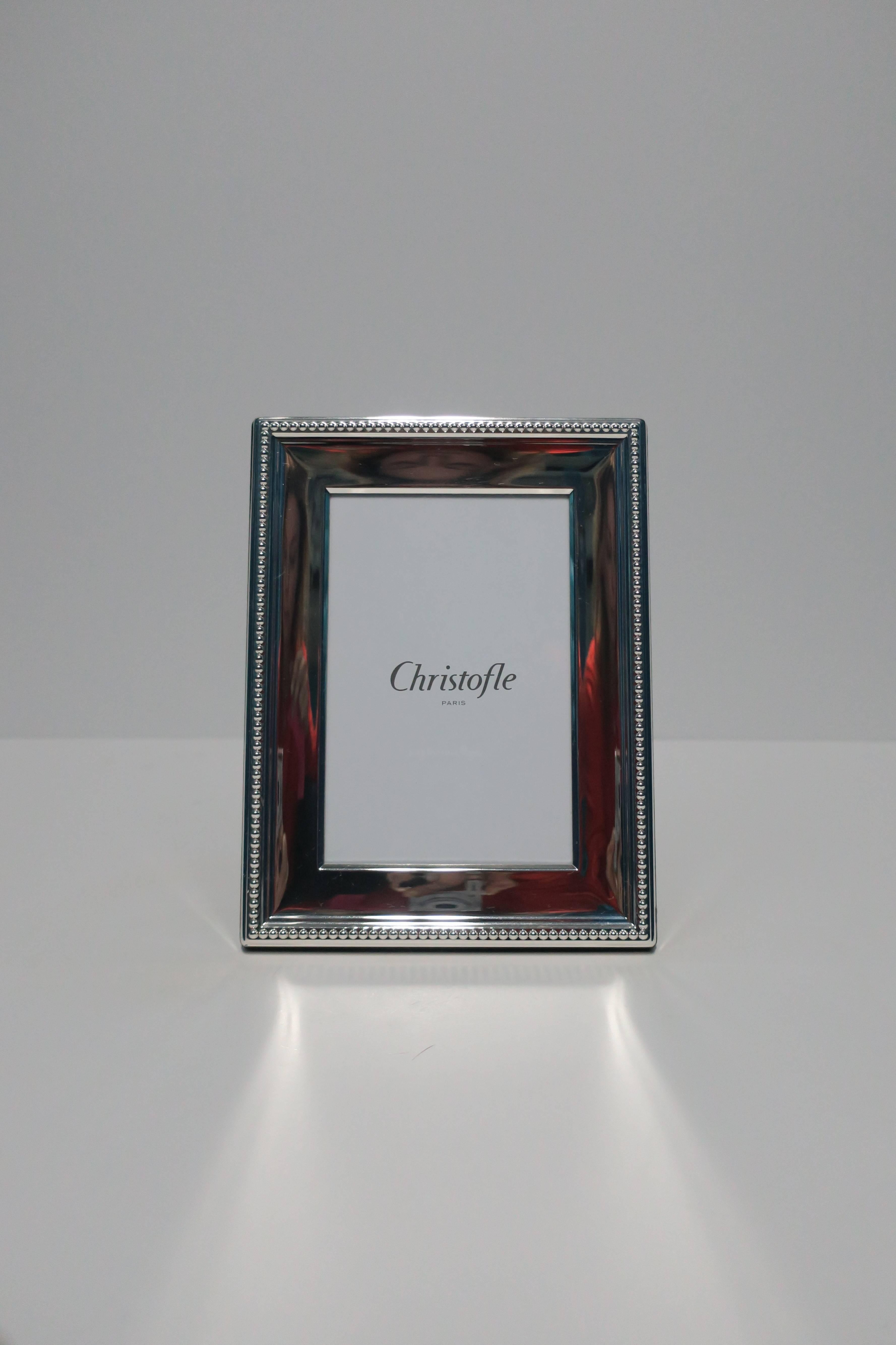 A beautiful picture frame by luxury brand Christofle. Frame is a sterling sliver plate covered with a clear lacquer to prevent tarnishing. Frame can be positioned vertically or horizontally, as show in images. With maker's mark on back. Frame