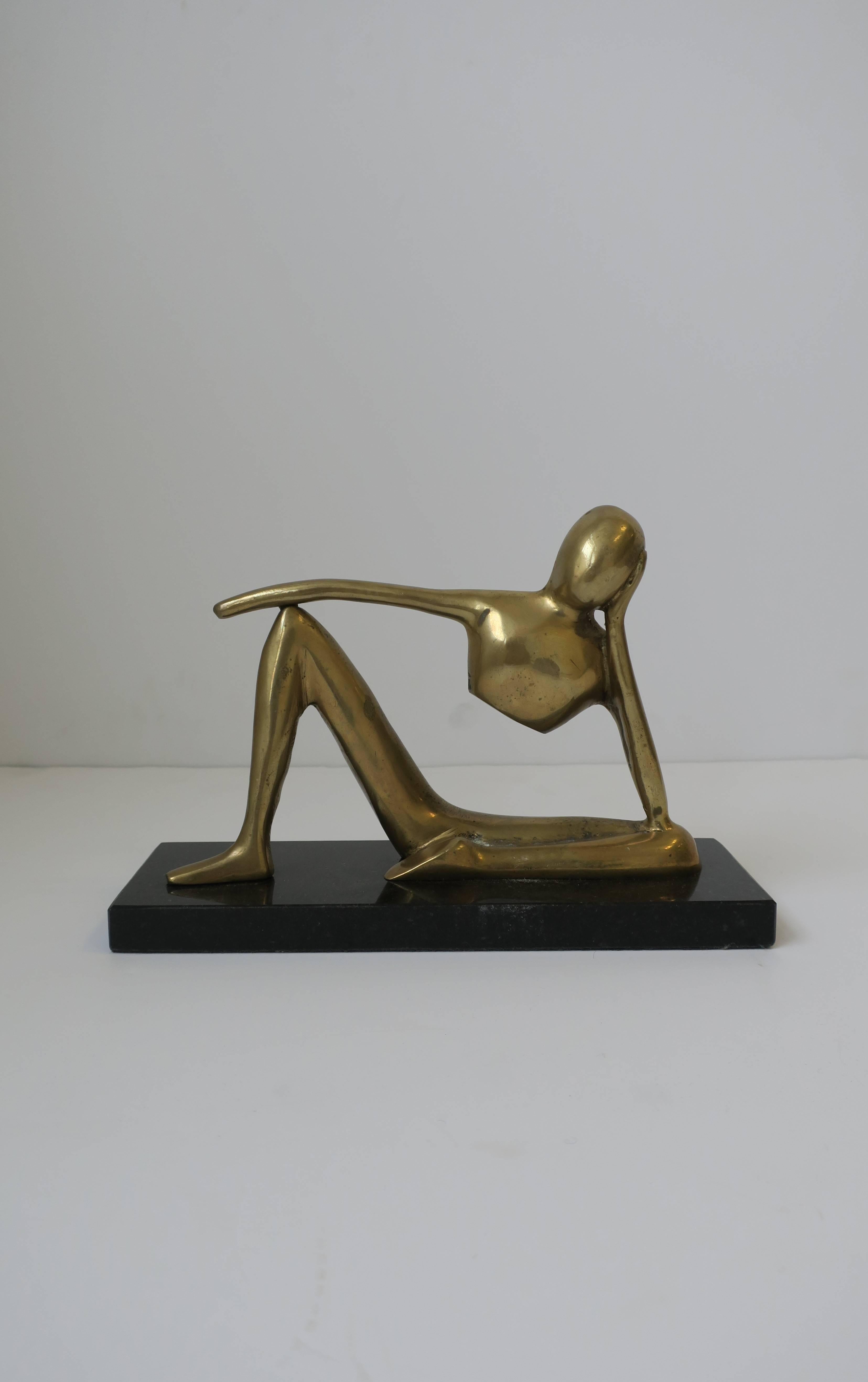 A substantial solid brass figural sculpture on black marble base, in the style of Sculptor Jean Hans Arp (1886 - 1966.) Sculpture on base measures 6 inches H x 9 inches W x 3 D. Item available here online. By request, item can be made available by