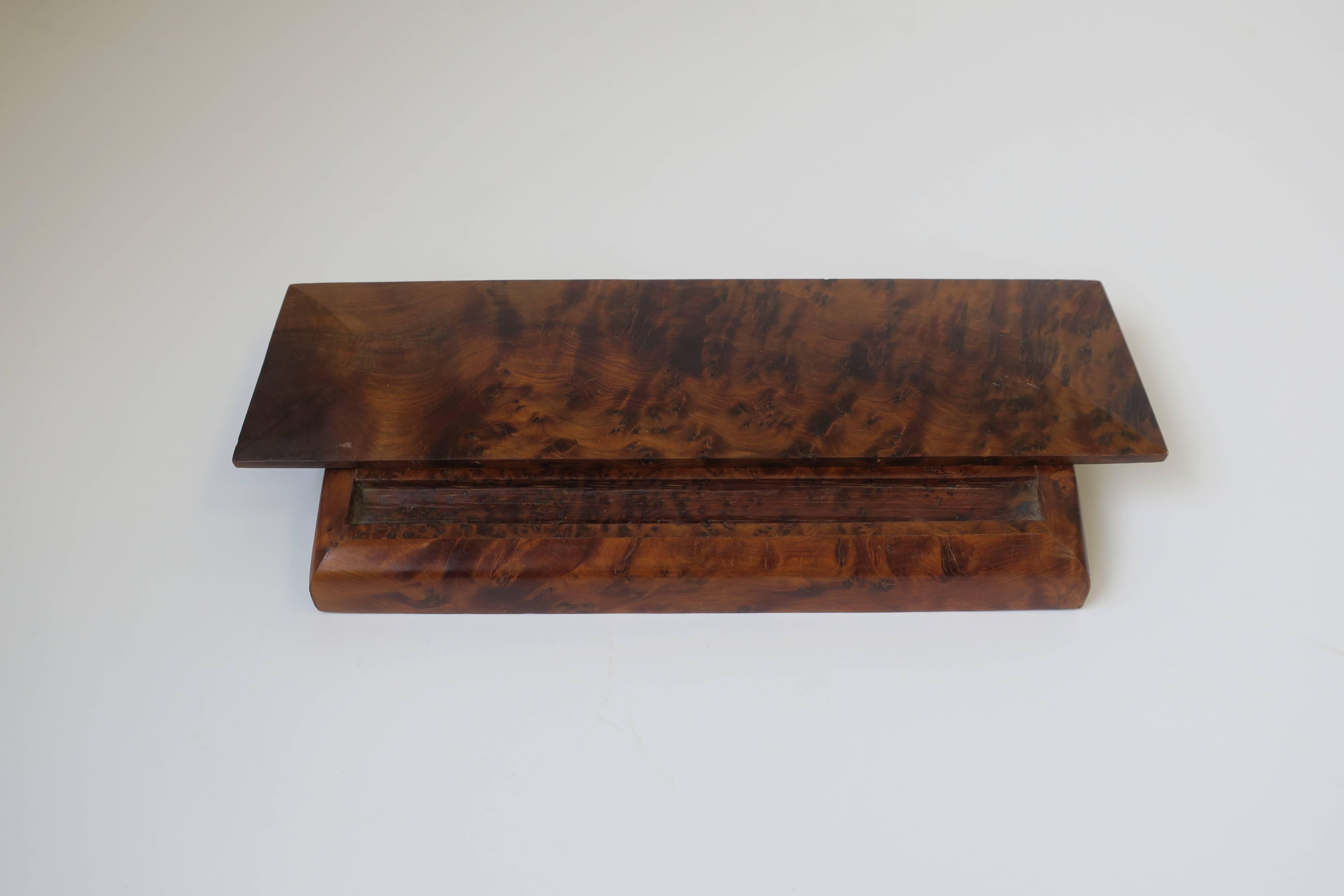 A beautiful rich burl wood vanity box or desk vessel, with area for pen or pencil. Box has a hinged lid (easy open/close.) Box is nice for smaller items such as cufflinks, earrings, rings, bracelets, etc., anything small you don't want to get