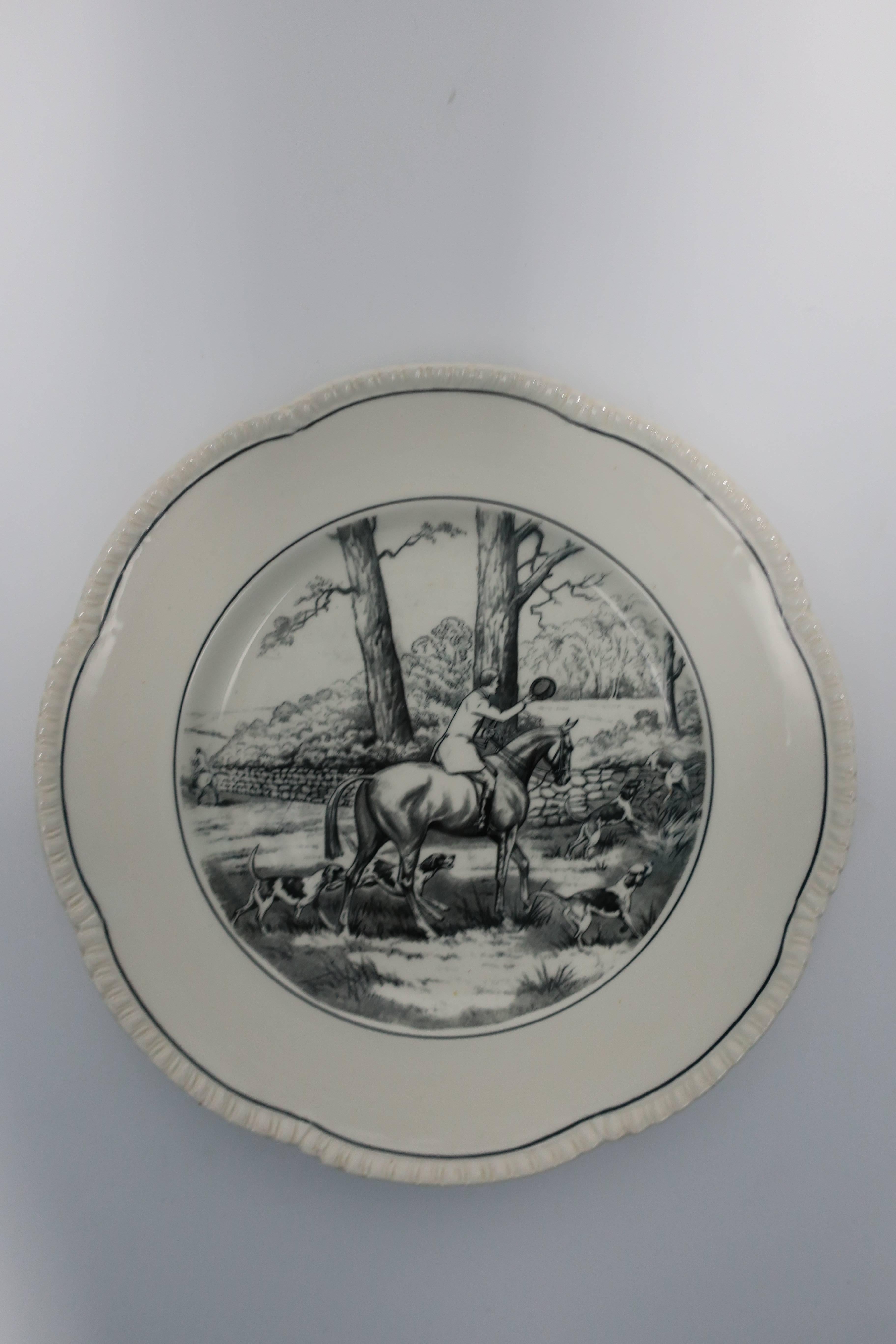 A beautiful black and white English porcelain plate depicting a country scene with horse, hunting dogs, and fowl birds. With maker's mark: Royal Caultron, England, est. 1774.

Measurements include: 10.5