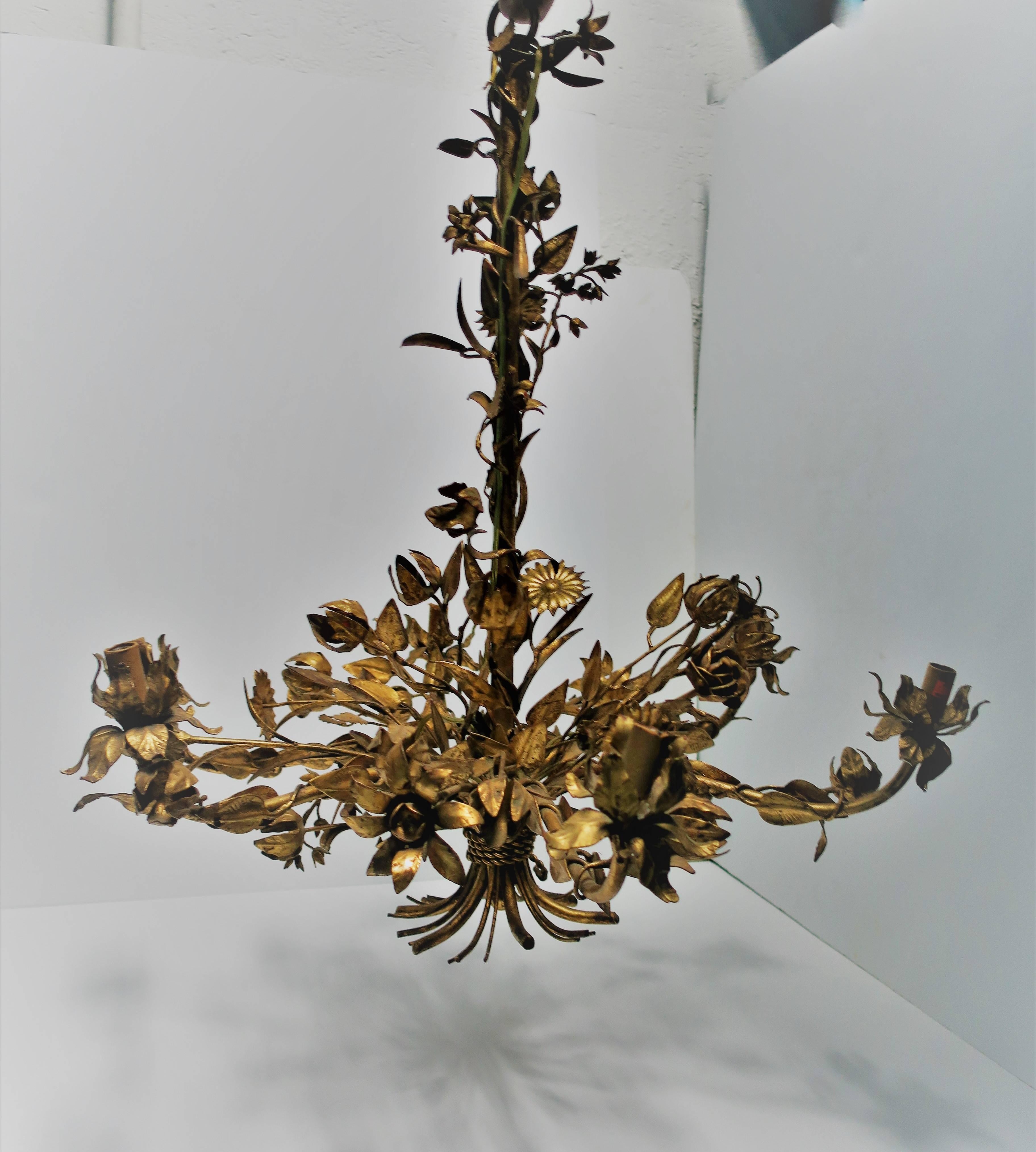A beautiful and striking Mid-Century Italian six-light gilt tole chandelier with flowers, buds, and leaves. Chandelier measures 29 inches high x 28 inch diameter. 

Item available here online. By request, item can be made available by appointment to