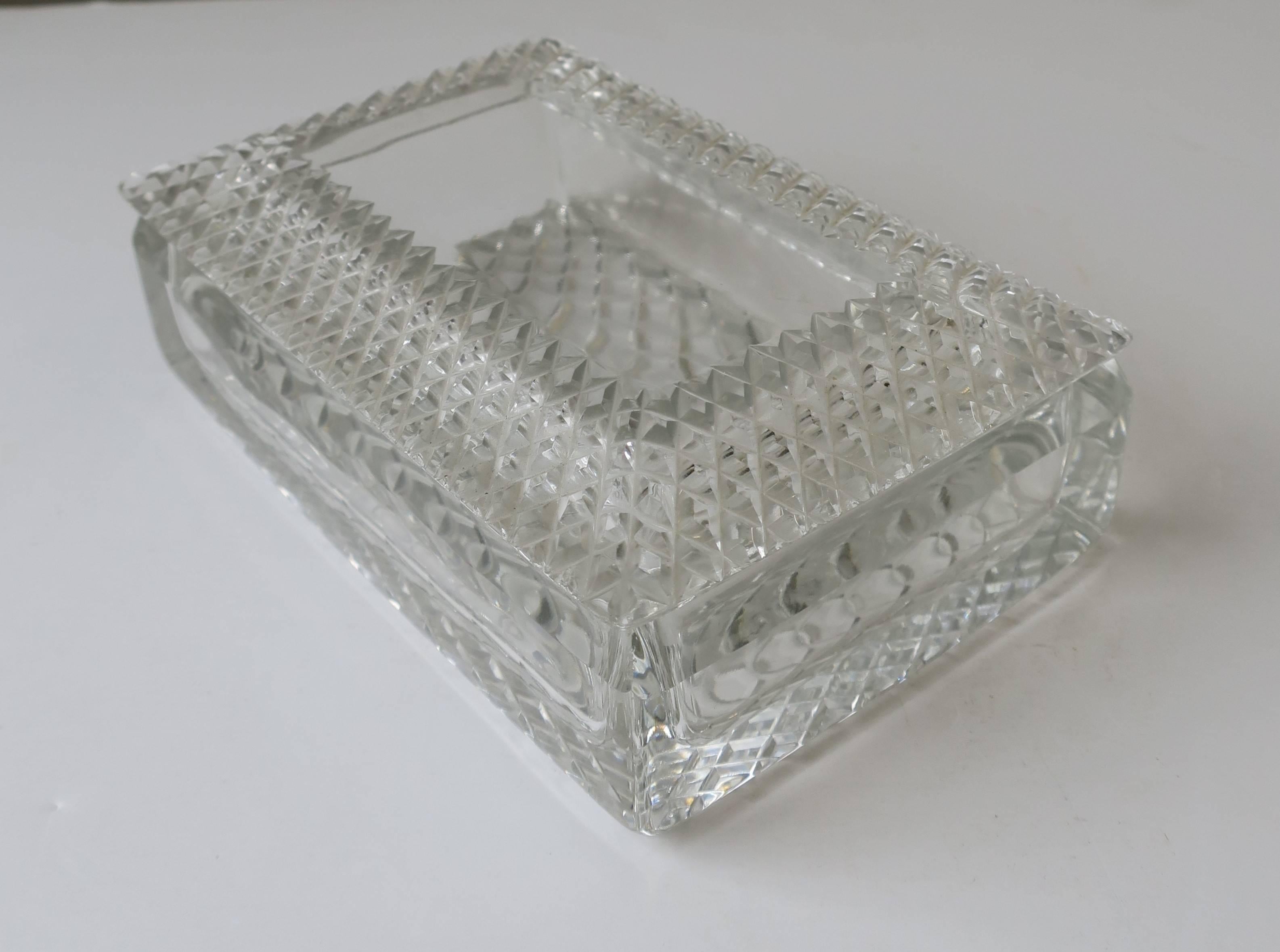 A beautiful vintage rectangular crystal jewelry or vanity box with a cut glass diamond quilted design pattern, circa Mid-20th Century. 

  