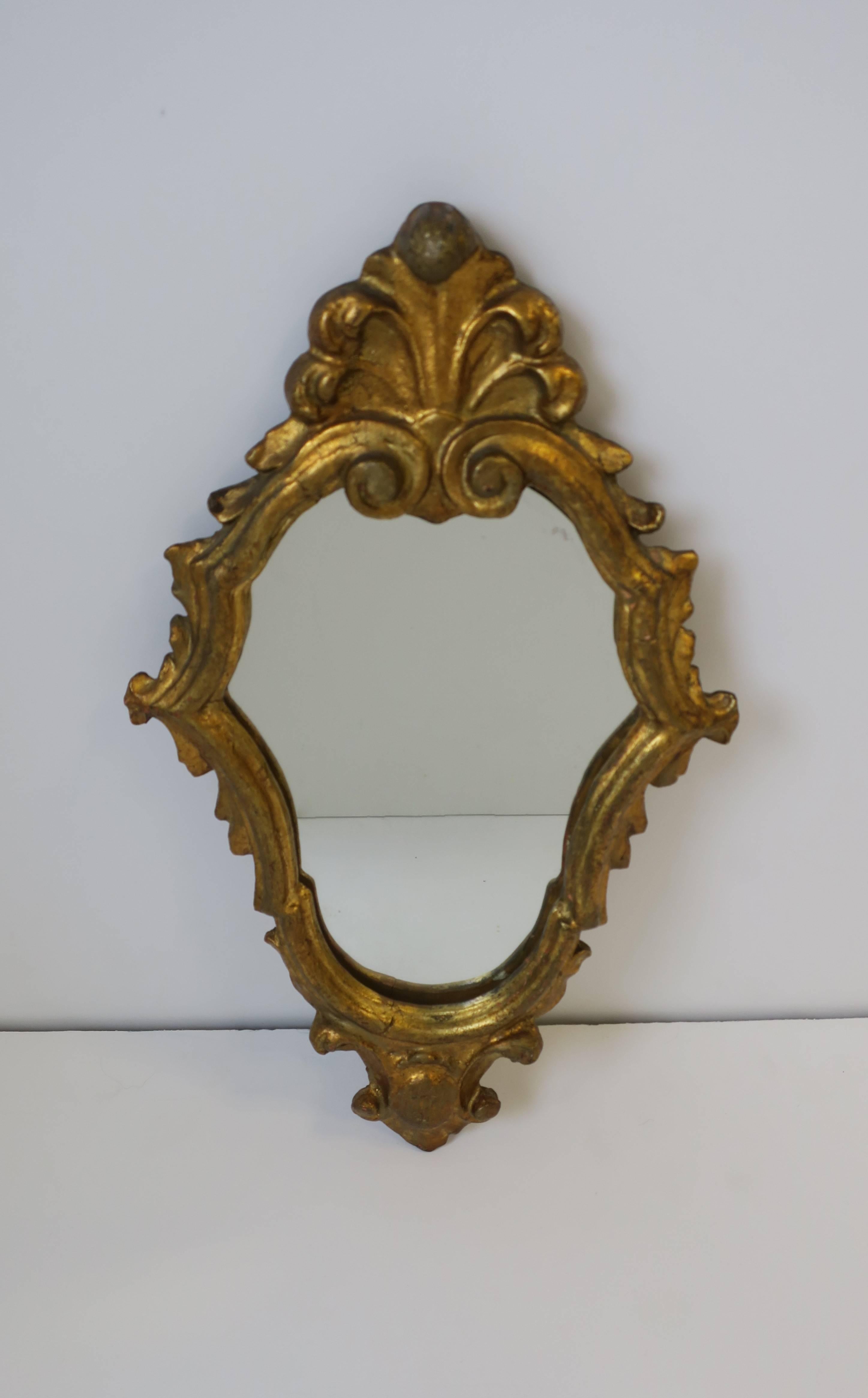 A beautiful petite Mid-Century Italian gold giltwood wall mirror, Italy, circa 1950s.

Item available here online. By request, item can be made available by appointment to the Trade in New York.
 