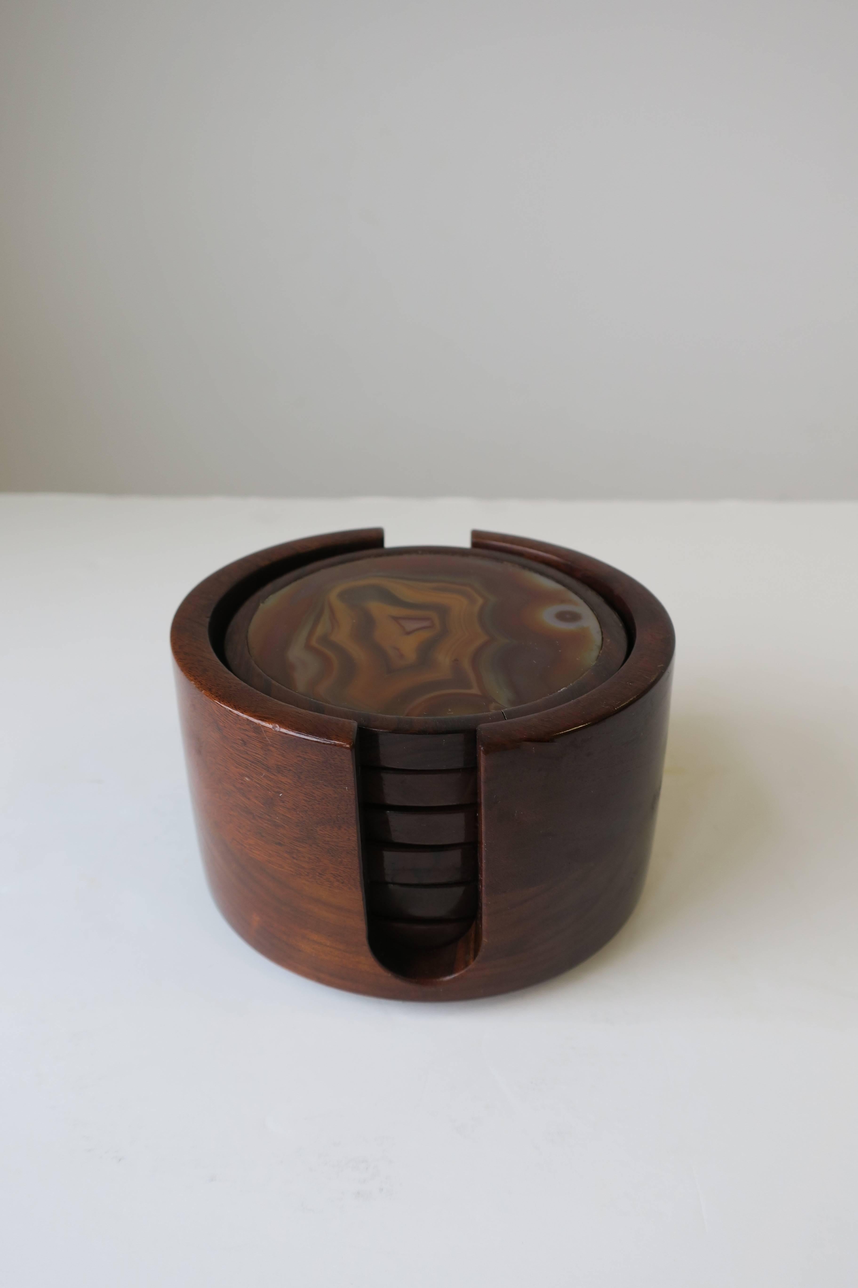 A beautiful Brazilian Modern rosewood and agate/onyx stone coaster set, circa 1970s, Brazil. Set includes six round agate/onyx stone and rosewood coasters and 1 coaster vessel. 7 pieces in total. Marked Made in Brazil as show in image #8. 

 