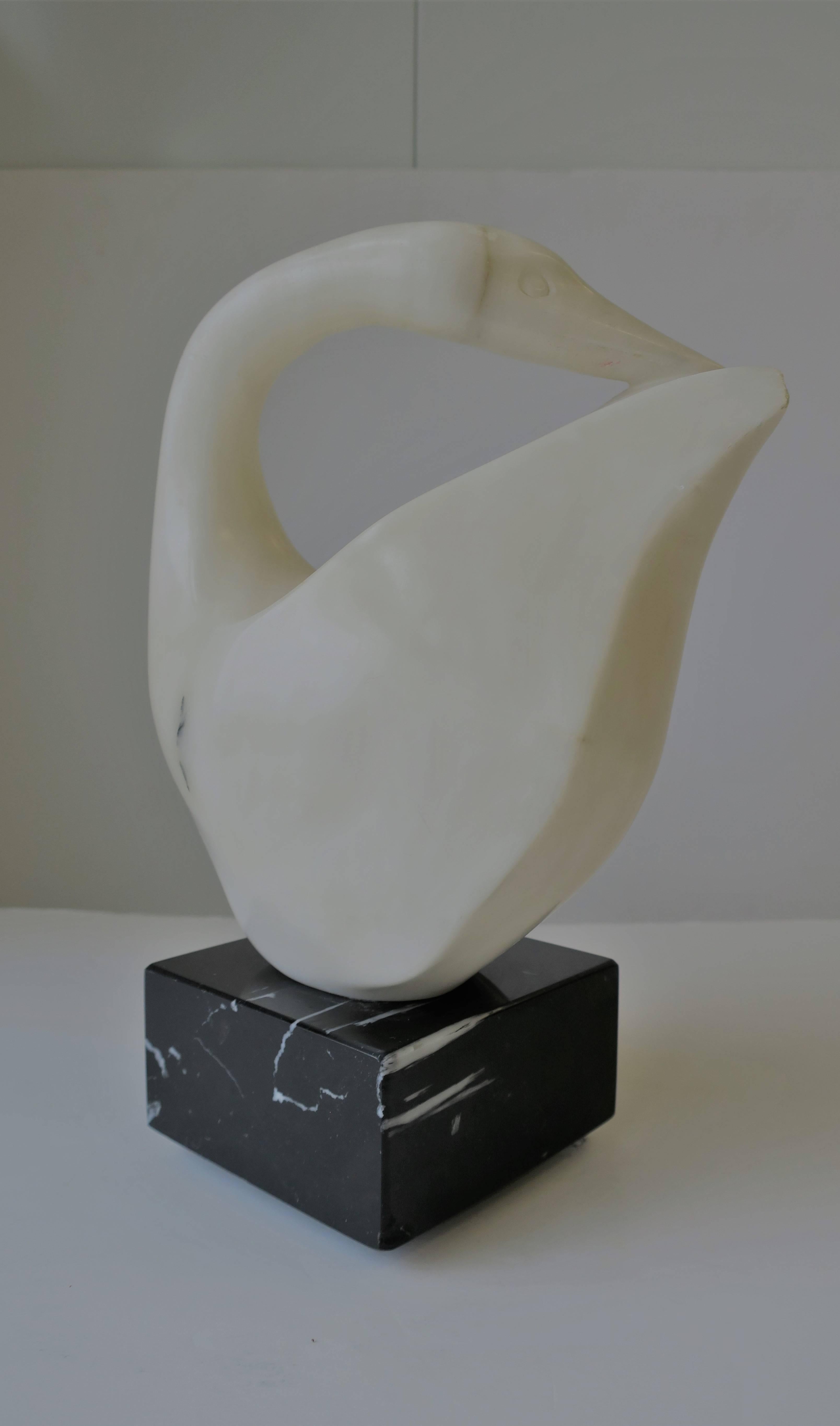 A Modern style black and white carved and polished marble swan bird sculpture on square marble base, circa 1980s. Piece is signed and dated on bird's base. Base rotates 360 degrees as shown in image #10. Sculpture measures: 10.75