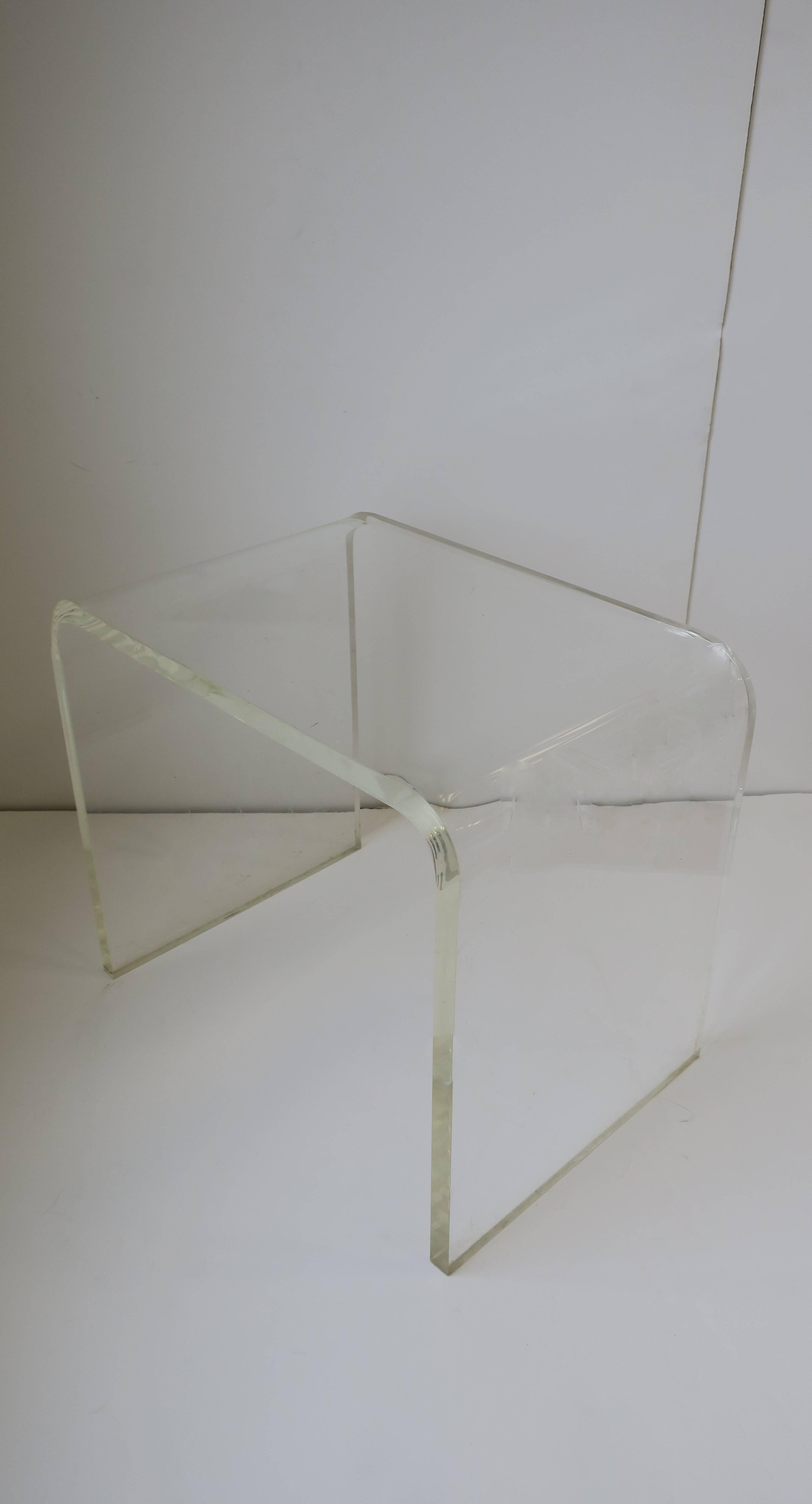 A thick modern style Lucite bench, end or side table. Item available here online. By request, item can be made available by appointment to the Trade in New York.
 