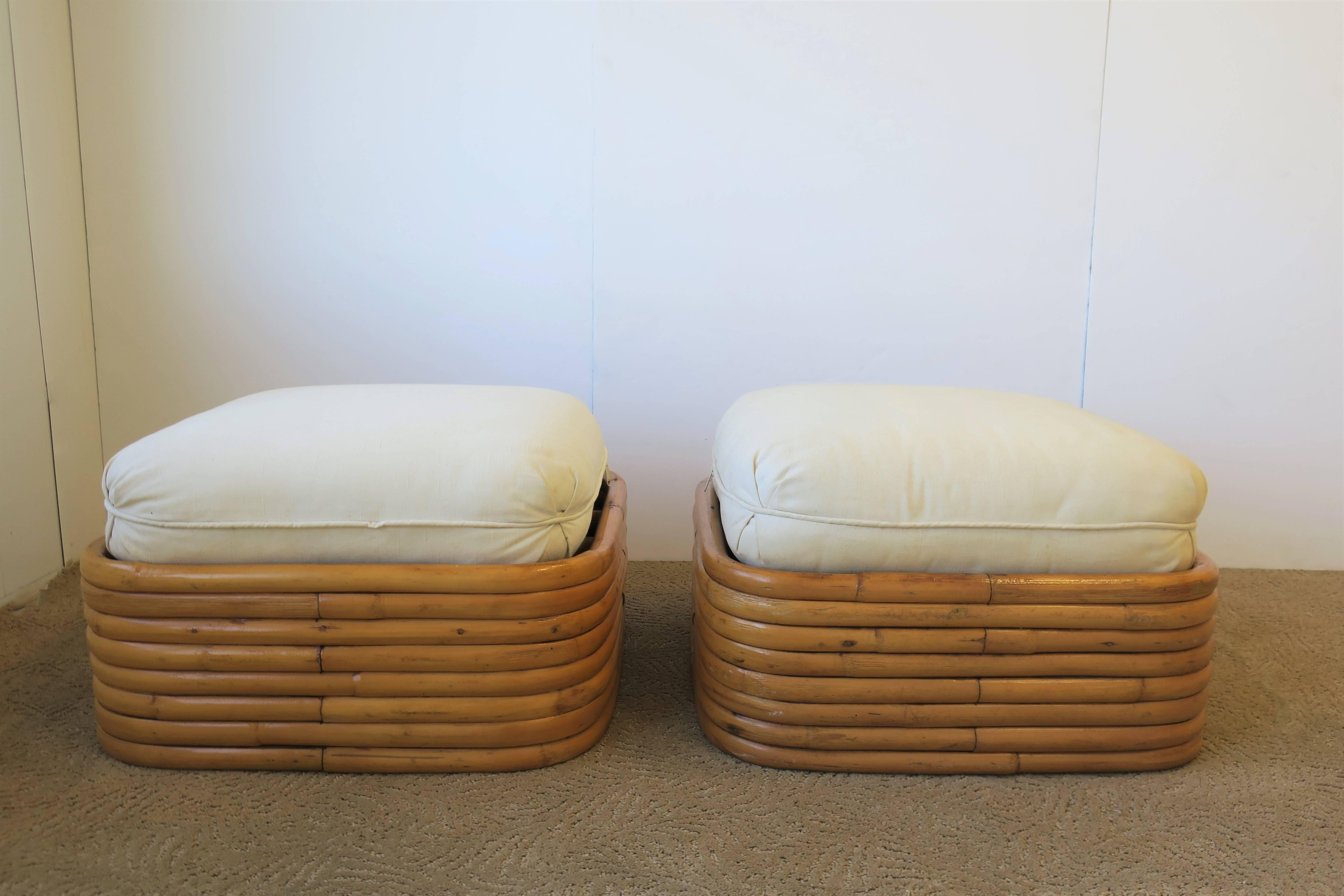 Vintage pair of Paul Frankl style stacked rattan benches or ottomans with upholstered seat cushions. Cushions are a sand or off-white hue. Each measures: 21.5 inches square x 8.5 inches high. 13 inches high with seat cushion. 

Pair available here