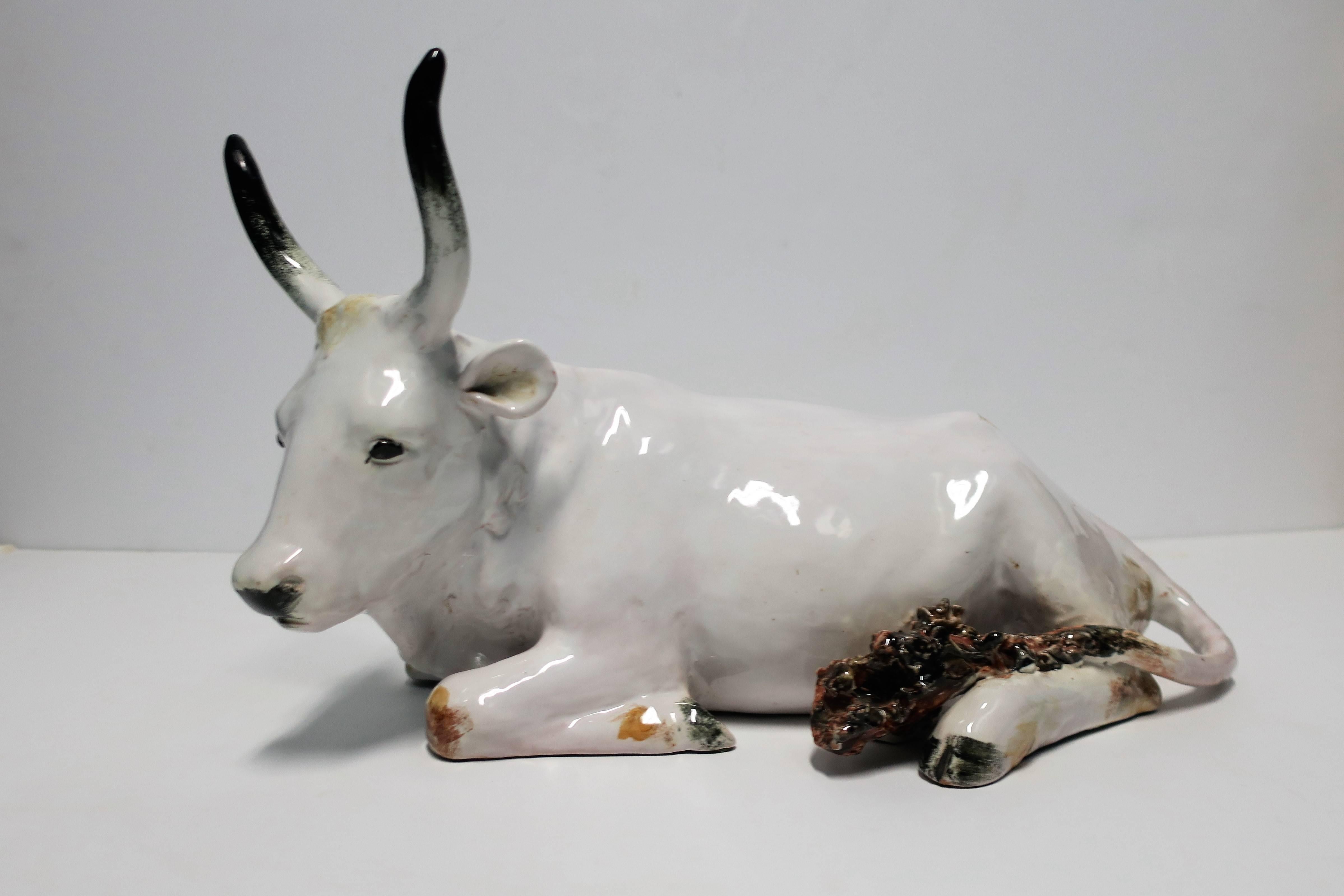 This is an amazing piece and relatively large too. This vintage Italian white bovine cow sculpture is hand-painted and made of glazed terracotta pottery; beautiful details include its large horns with black tips, ears, eyes, nose and tail. Image #4