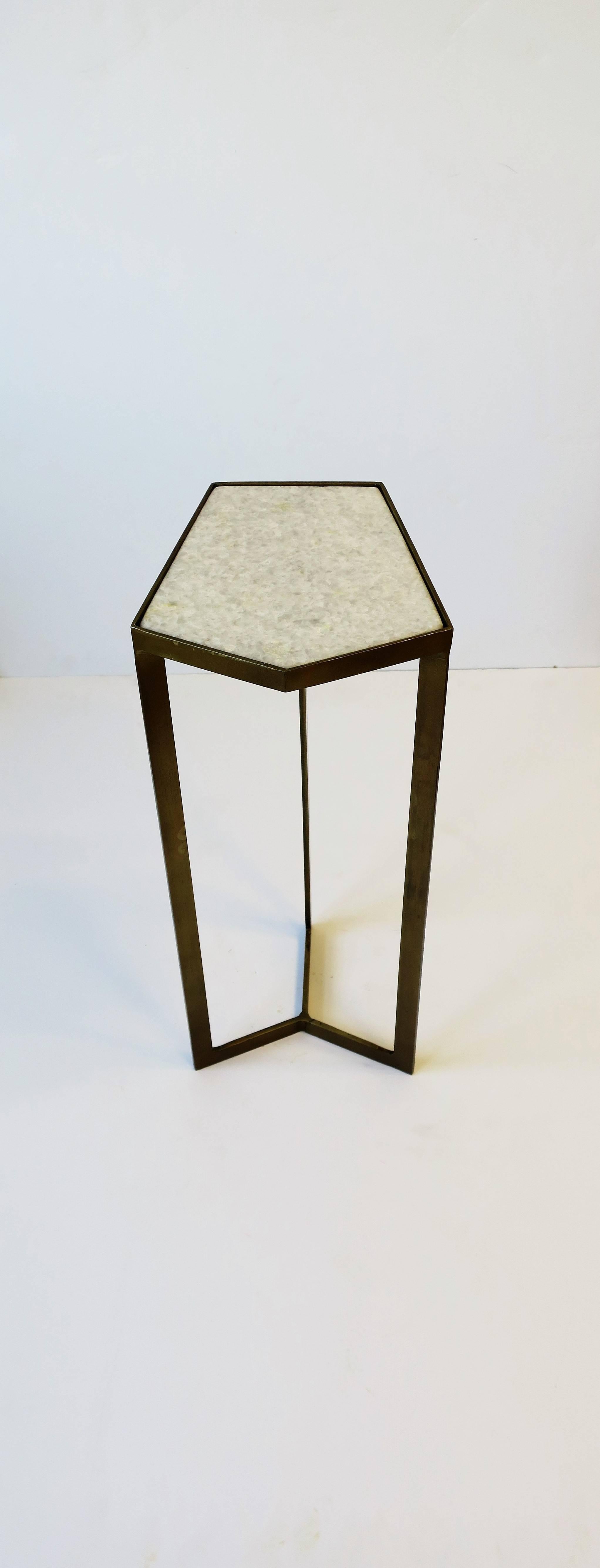 A Minimalist style geometric matte gold powder-coated metal side or drinks table with a white granite marble stone top. A small and convenient side/drinks table. In situation, please see images #18 and 19. 

Table measures: 7