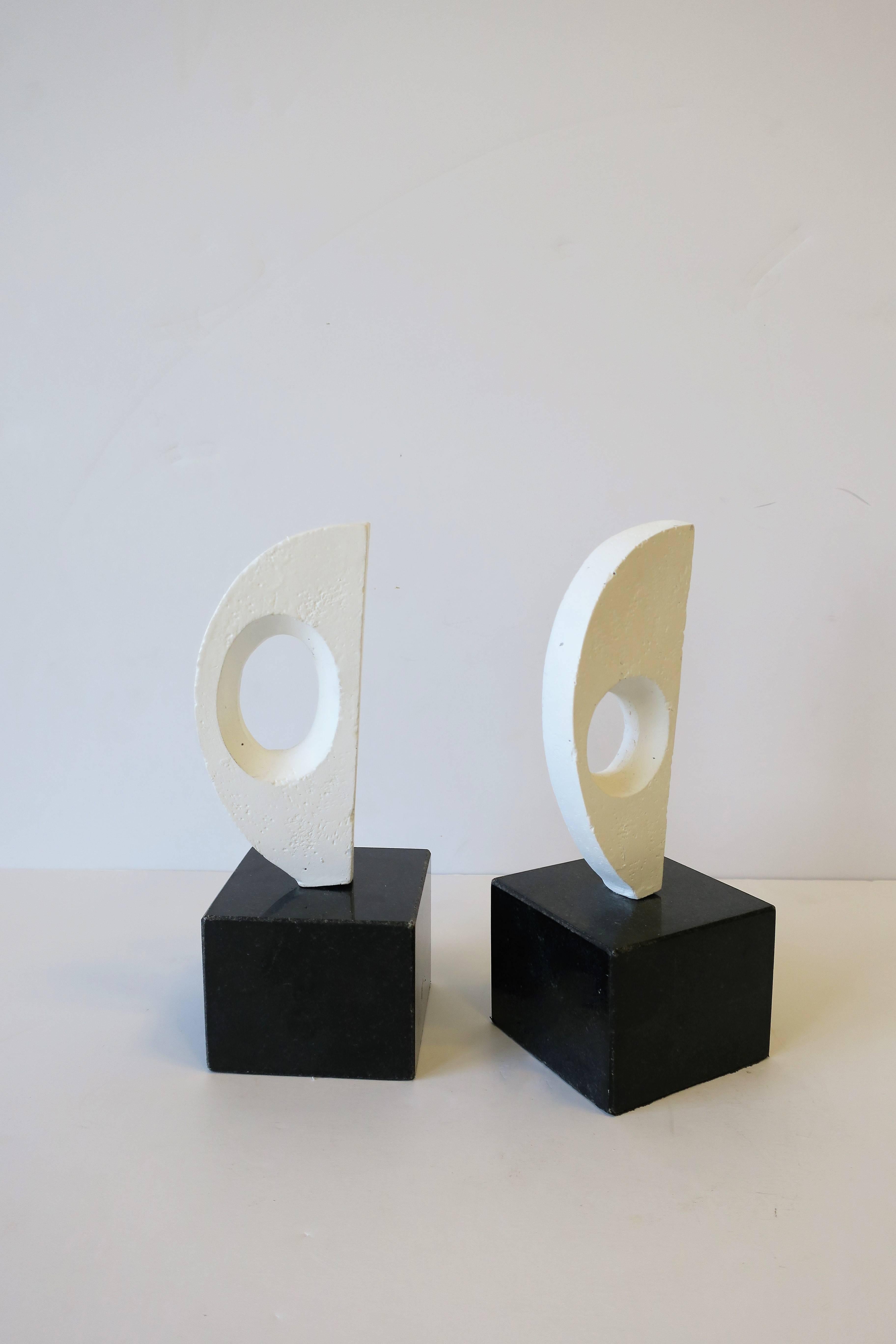 Pair of black and white abstract sculpture bookends. Bases are black marble or granite. Measurements include: 8.25 in. high x 3.25 in. square base.

Pair of available here online. By request, pair can be made available by appointment to the Trade in