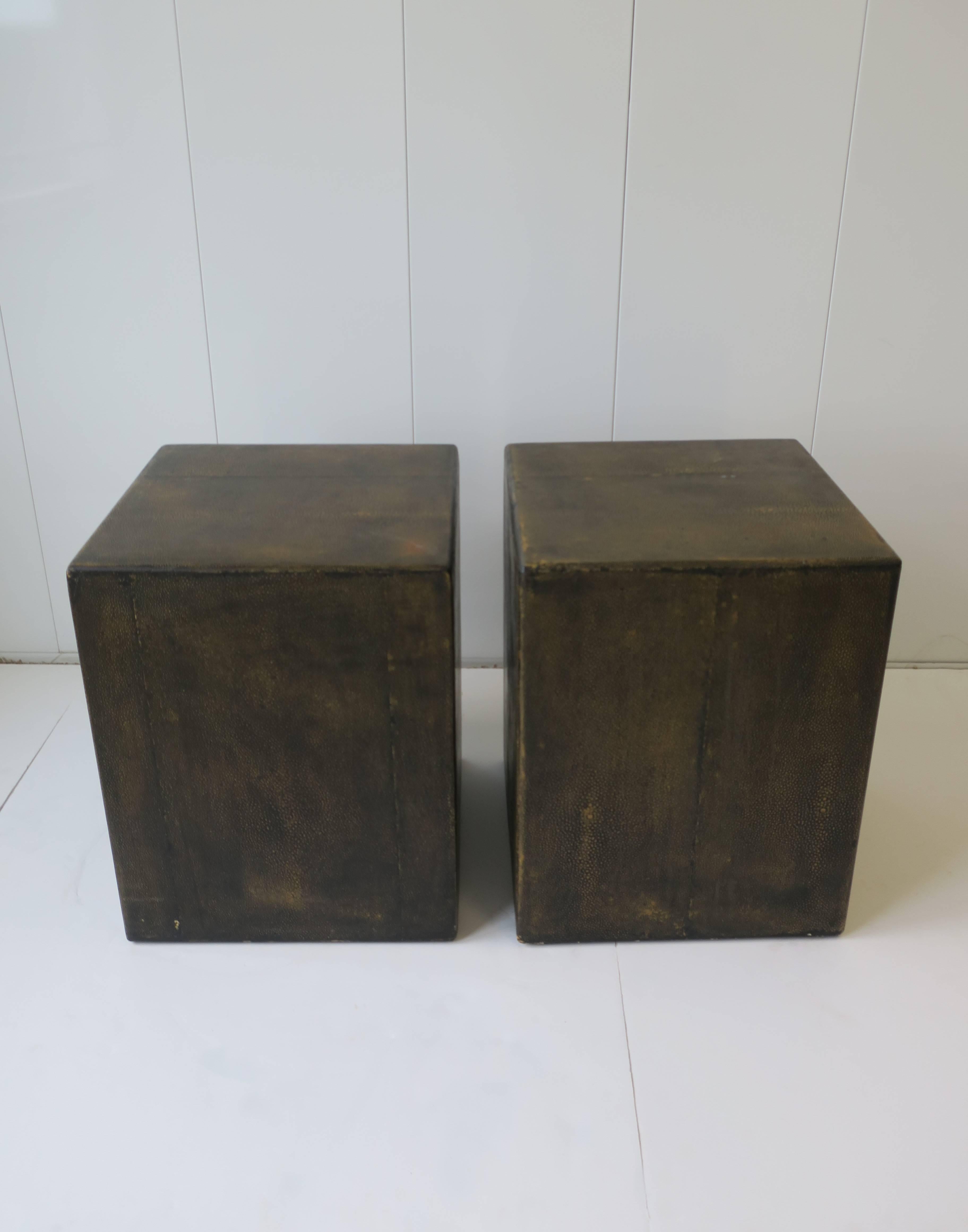 A vintage pair of Modern style Shagreen-esque pedestal end or side tables in black with a tan or gold undertone. Close-up in image #10. Measurements include: 15 inches square x 19 inches high. 

Pair available here online. By request, pair can be