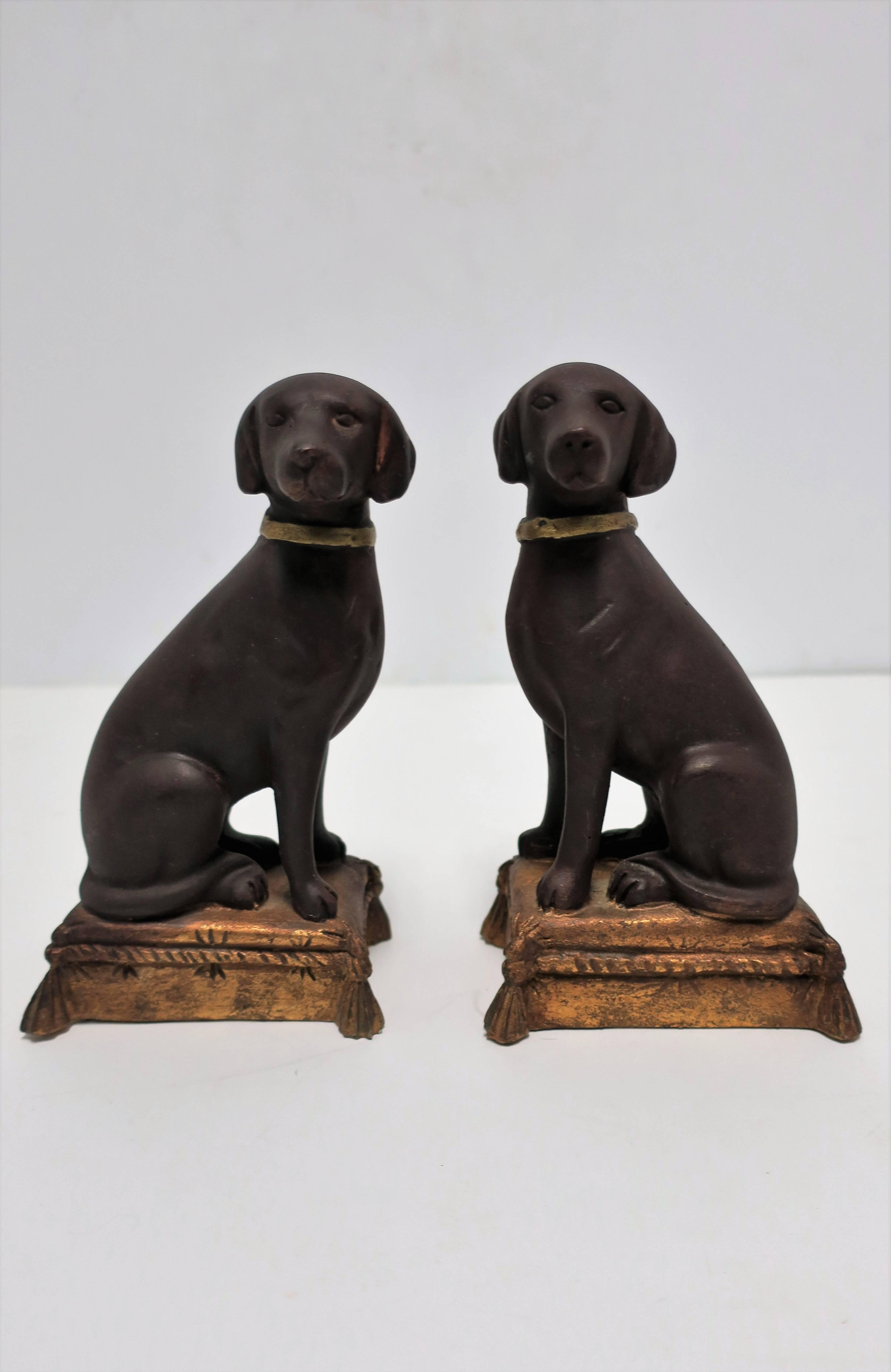 Early to Mid-Century substantial pair of chocolate brown Labrador Retriever dog bookends. Dog's are wearing gold collars are sitting on a gold pillow with tassel details. Hand-Painted. Each measure: 7.5 in. H x 4.5 in. W x 3 in. D. 

Item