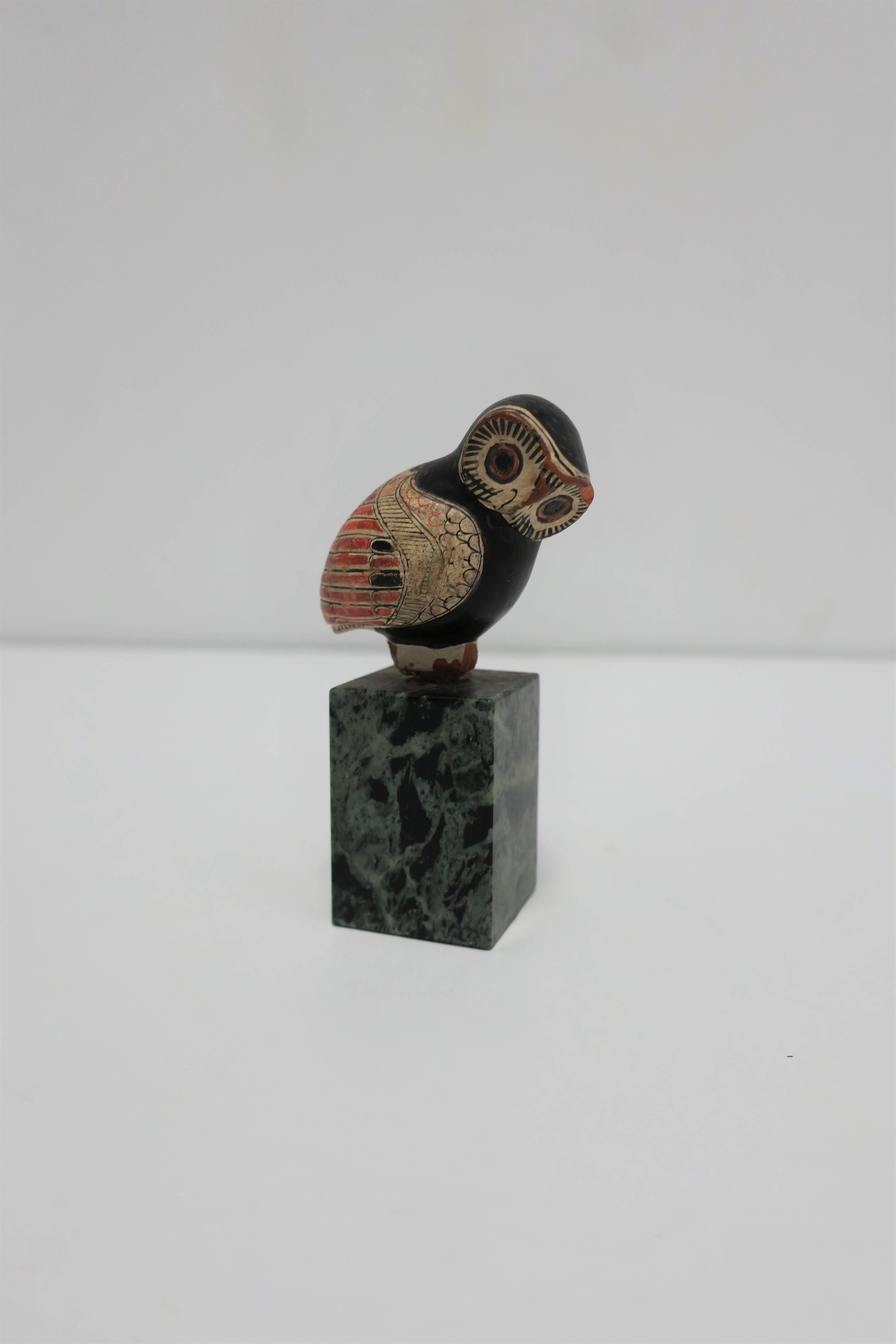 A beautiful and unique small vintage decorative hand-painted owl bird sculpture on a rectangular green marble pedestal base. 

Piece measures: 4.25 in. H x 2.5 in. 2.5 in. 

Item available here online. By request, item can be made available by