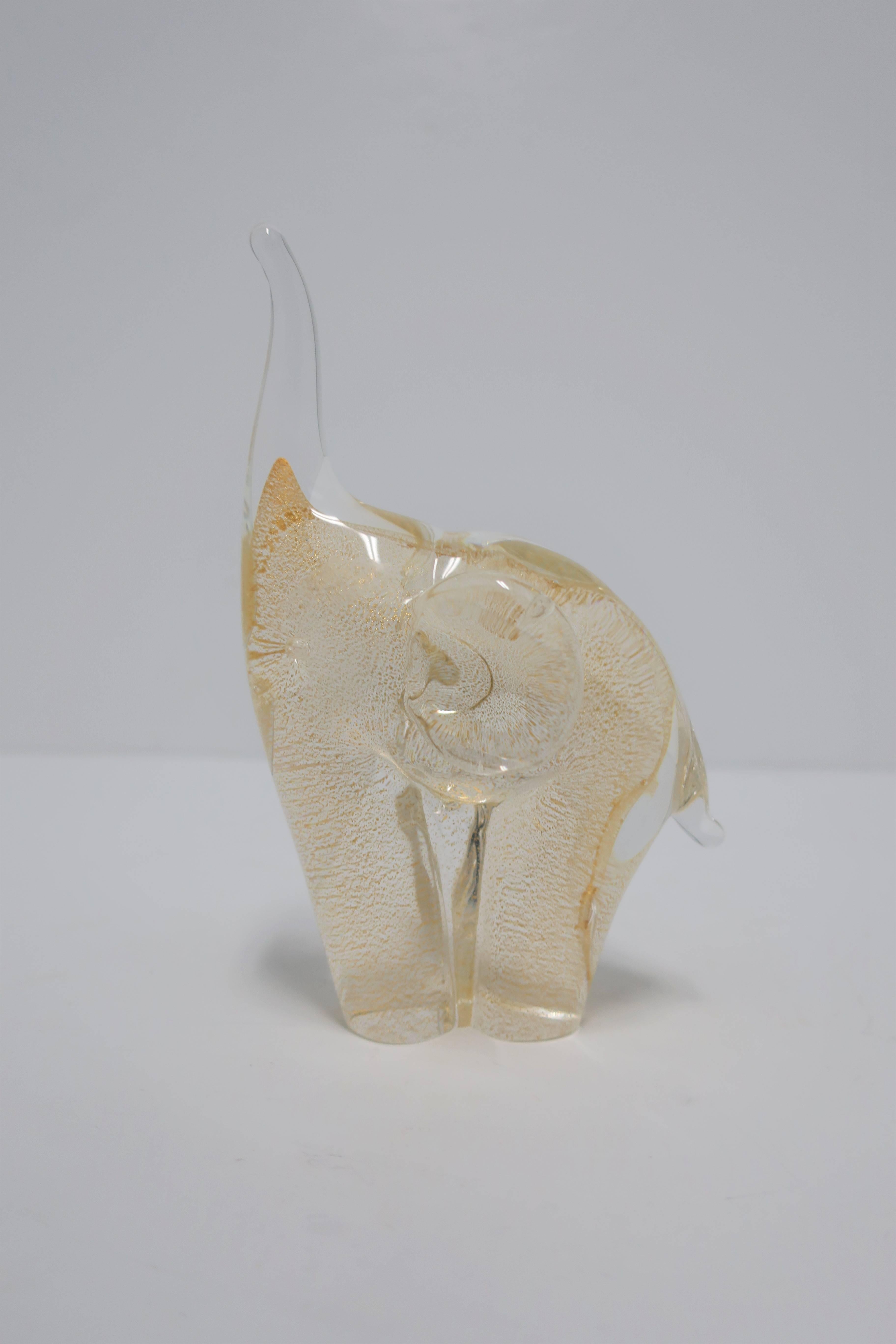 A beautiful clear with gold art-glass Elephant sculpture. This clear and gold art-glass elephant is in the style of Italian designers Franco Albini or Archimede Seguso.

Elephant measures: 6 in. H. x 4 in. x 3 in. W. 

