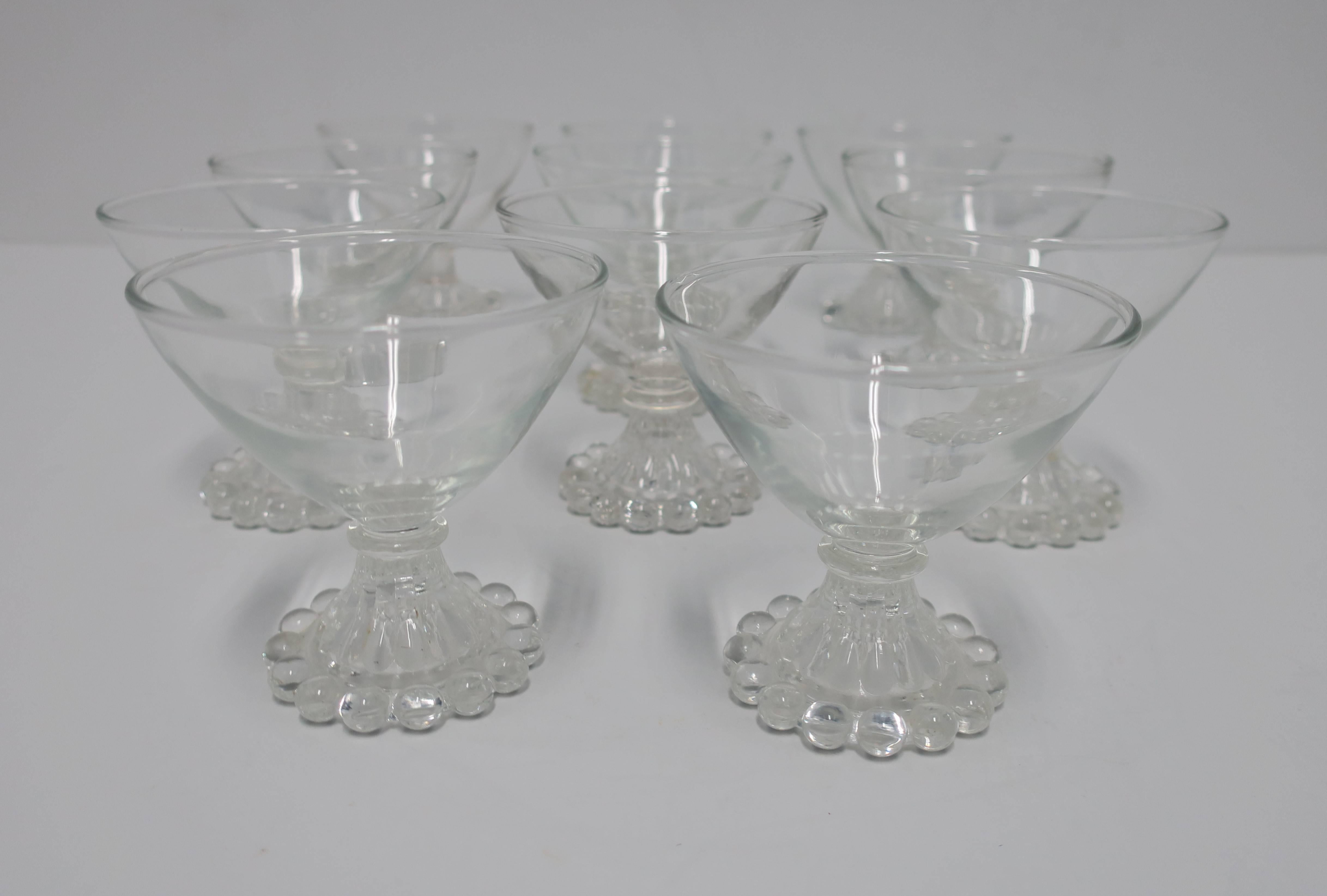 A beautiful set of 12 cocktail or champagne glasses with decorative base, circa early 20th century. Glasses could also be used to serve dessert. A great set for summer or holiday entertaining. 

Each measure: 3.5