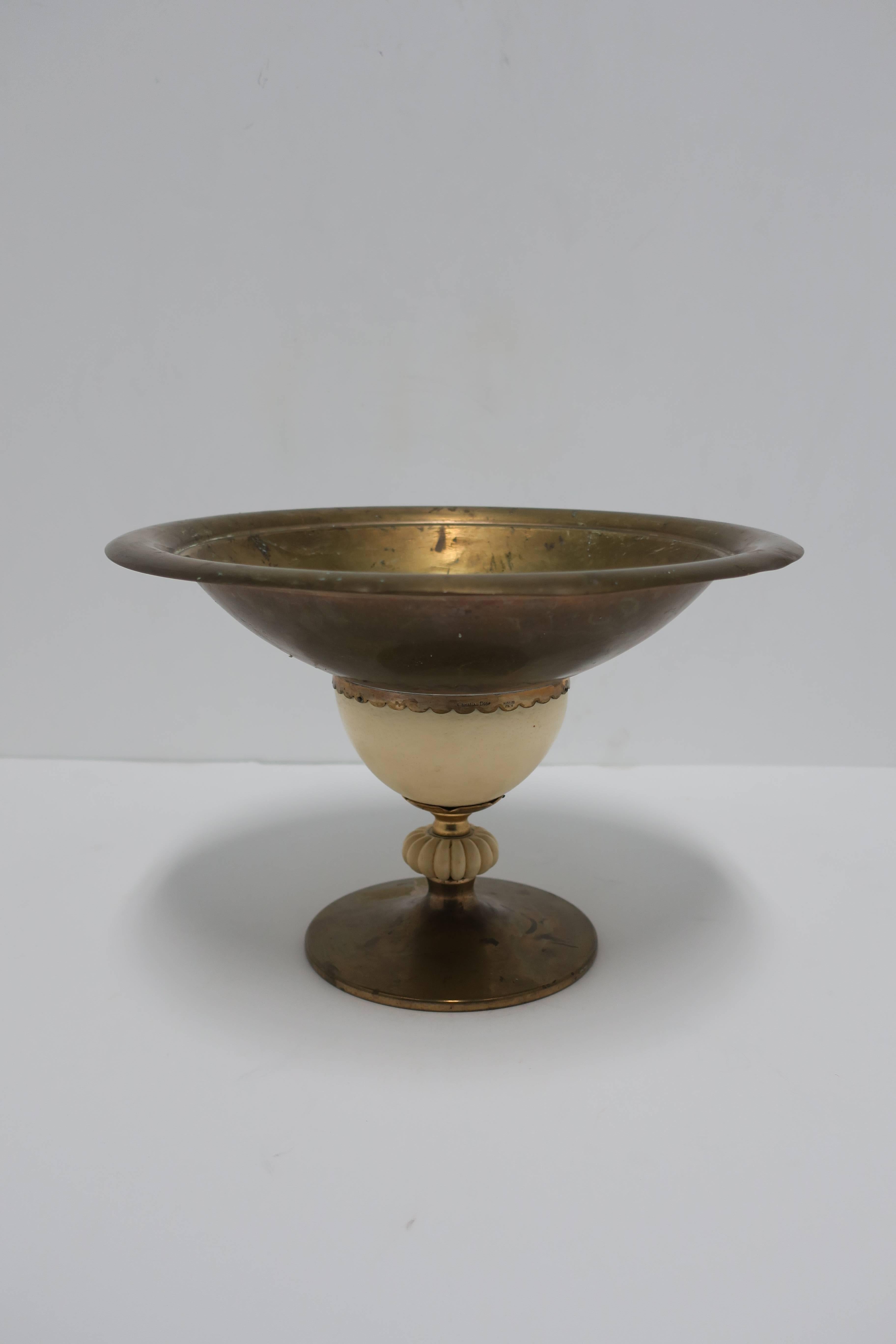A beautiful designer vintage Italian brass and ostrich egg compote, centerpiece, tazza, or footed bowl by Christian Dior, Made in Italy. Piece is marked: 'Christian Dior', 'Italy', on scalloped brass edge on side as show in image #10. 

Piece