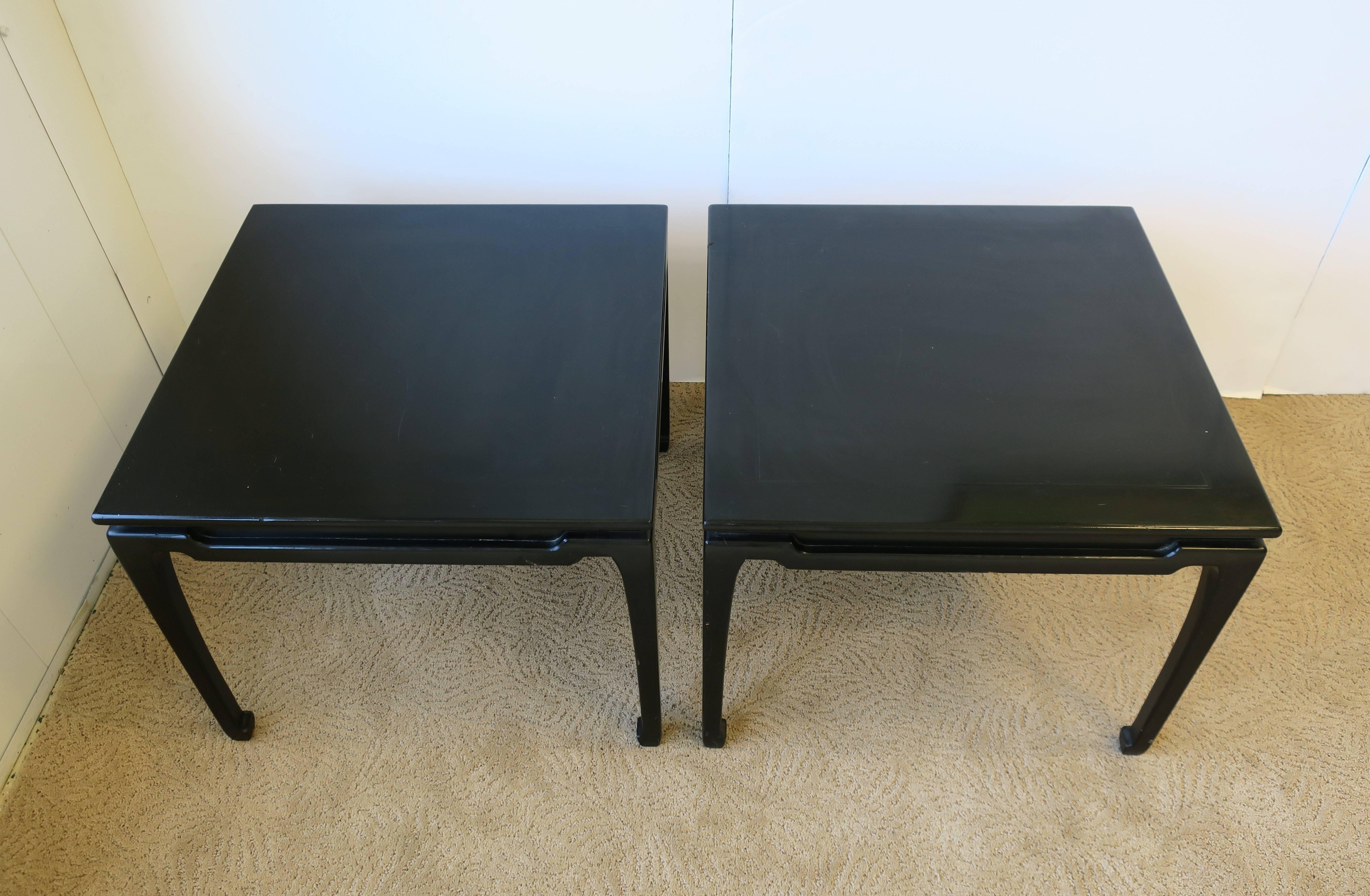 A beautiful pair of black lacquered wood end tables, circa 1970s. Black finish, professionally applied, has a nice sheen/shine (NOT a high gloss.) Tables can be used as end tables or side-by-side as a coffee/cocktail table. Modern lamp shown in