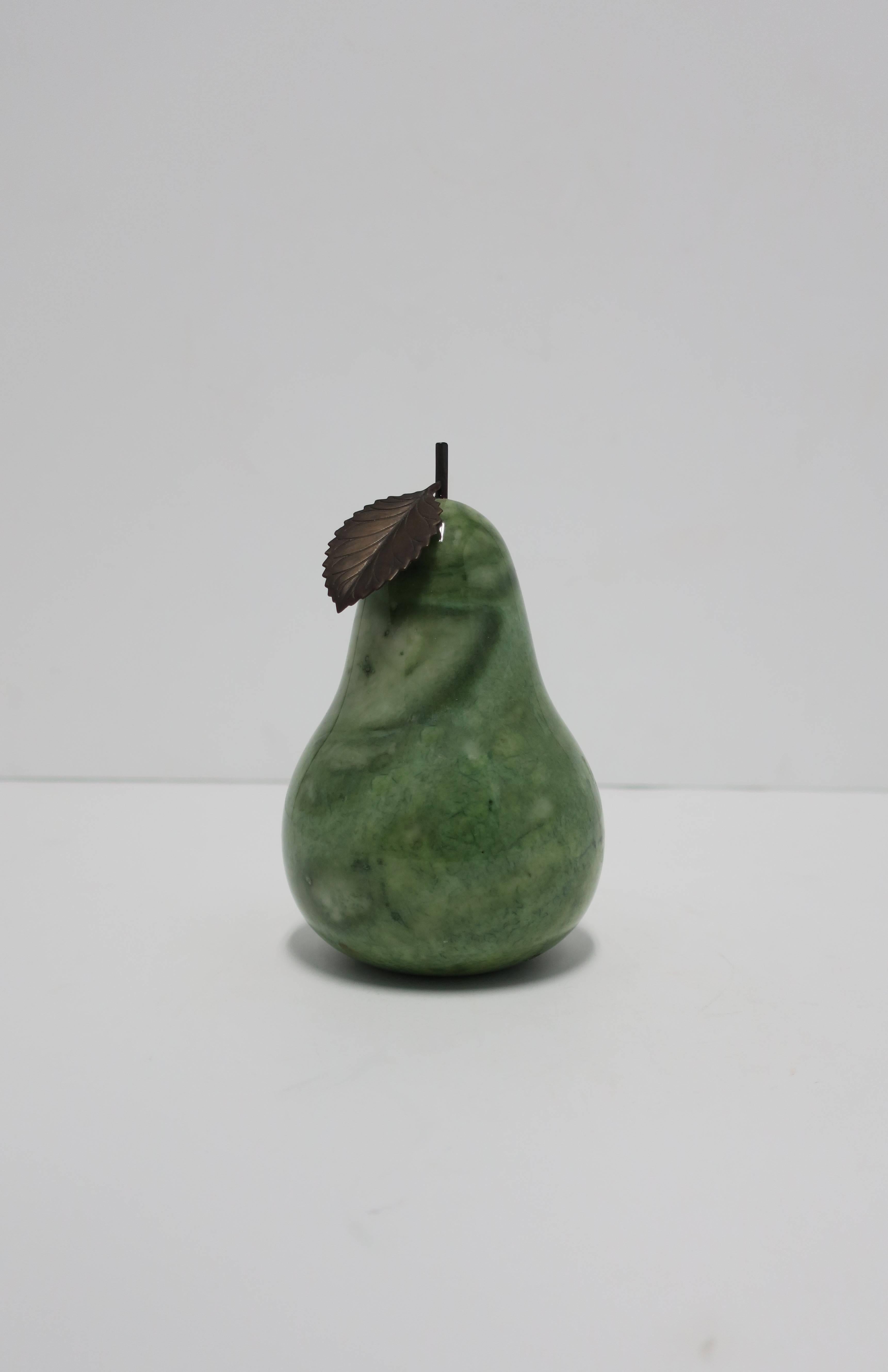 A beautiful Italian green alabaster marble decorative pear sculpture with leaf and vine design, Italy. Alabaster marble pear is polished smooth with brownish metal leaf and vine design at top. Label on bottom reading hand-carved from Italy. 

Pear