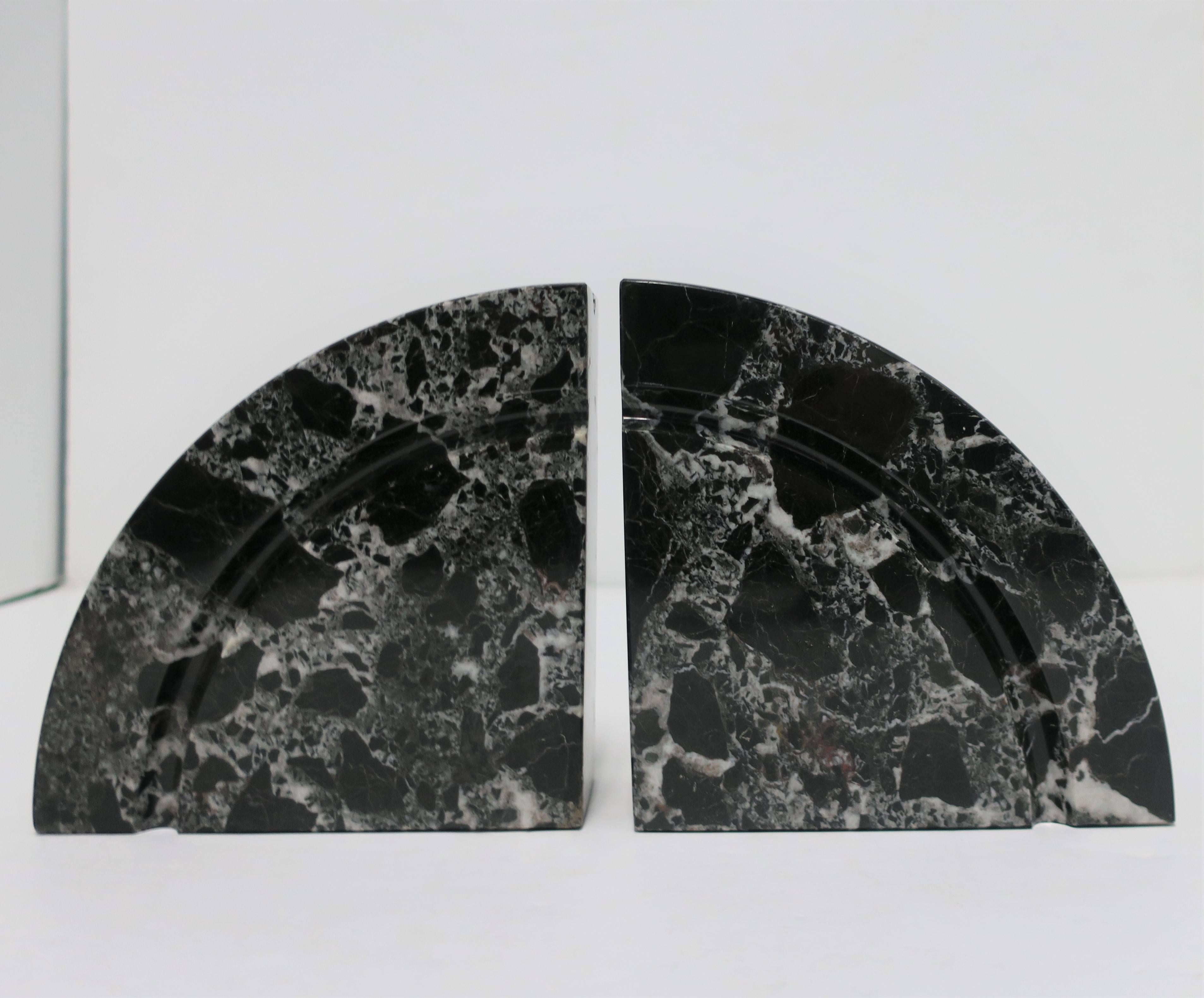 A substantial pair of '70s Modern or Post-Modern period, black and white marble bookends in a half-moon or demi-lune shape, circa late-20th century, 1970s.

Each measure: 6