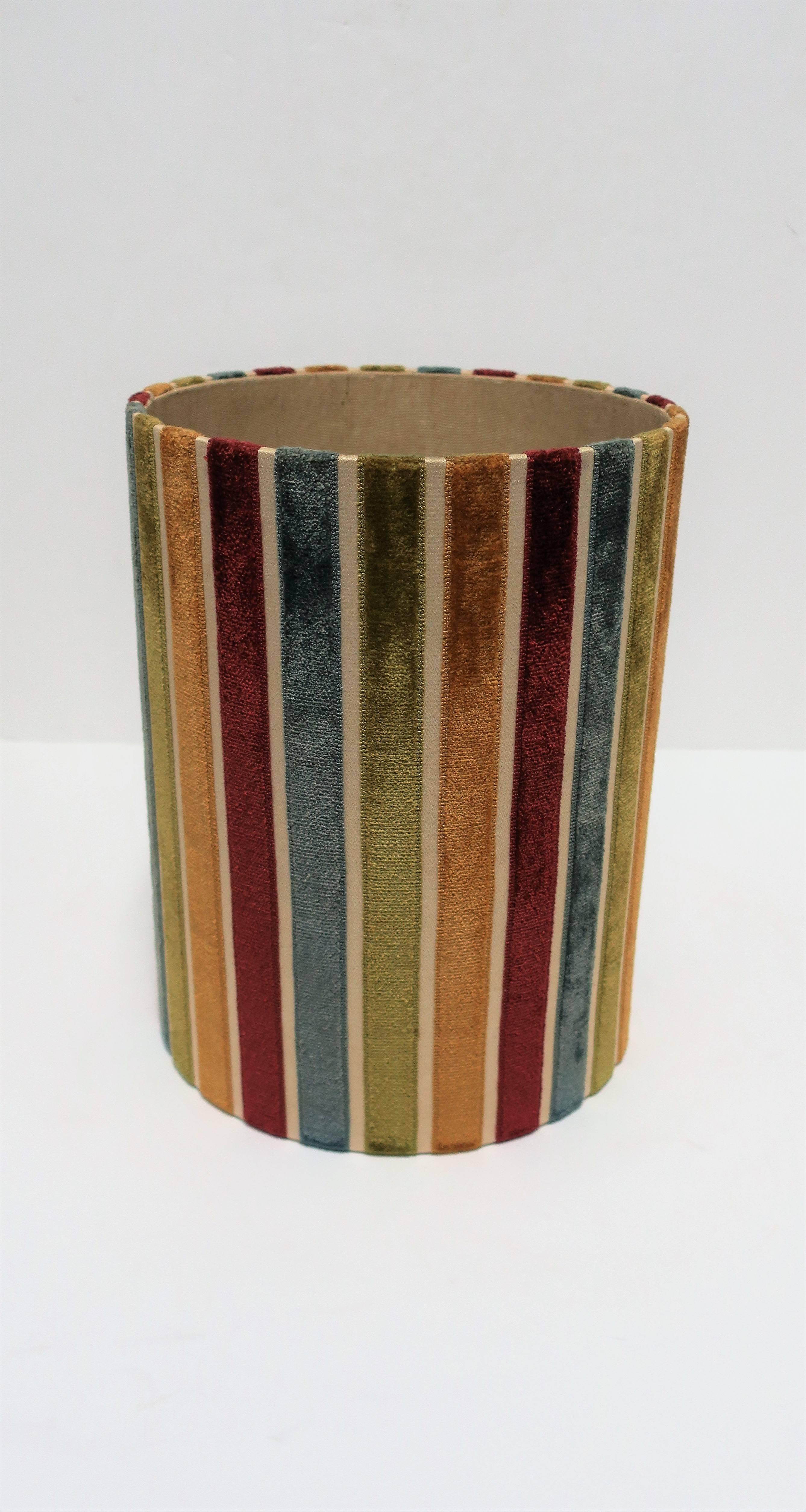 A vintage multicolored velvet striped wastebasket [waste basket] or trash can. Velvet colors include: gold, red, blue, and green. Material lining. 

Measures: 10.5 in. diameter x 13 in. H. 


 