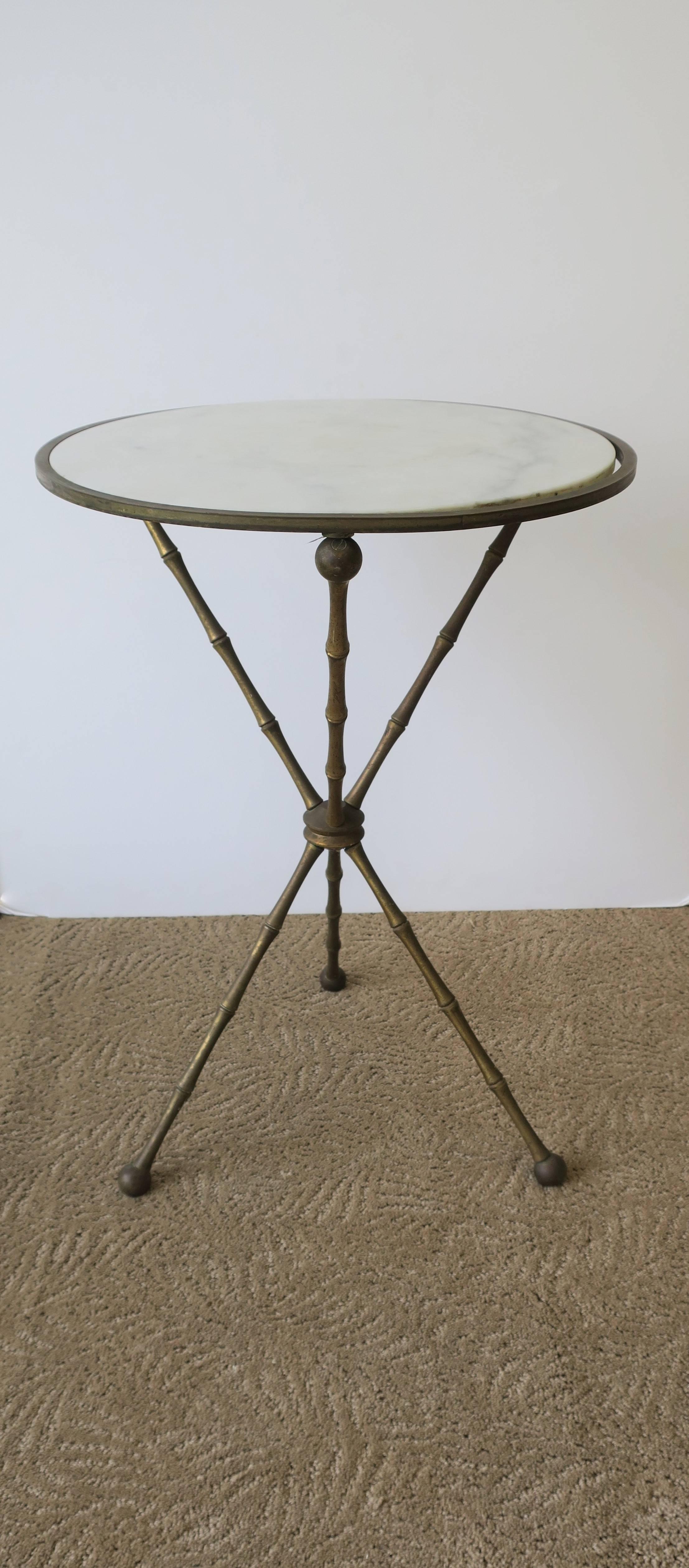 A Mid-Century Italian marble tripod or gueridon side table featuring a brass frame in a 'bamboo' design. Marked 'ITALY' underneath as show in image #5, Italy, circa 1960s. 

Table measures: 23 in. H x 16.75 in. diameter. 

Item available here