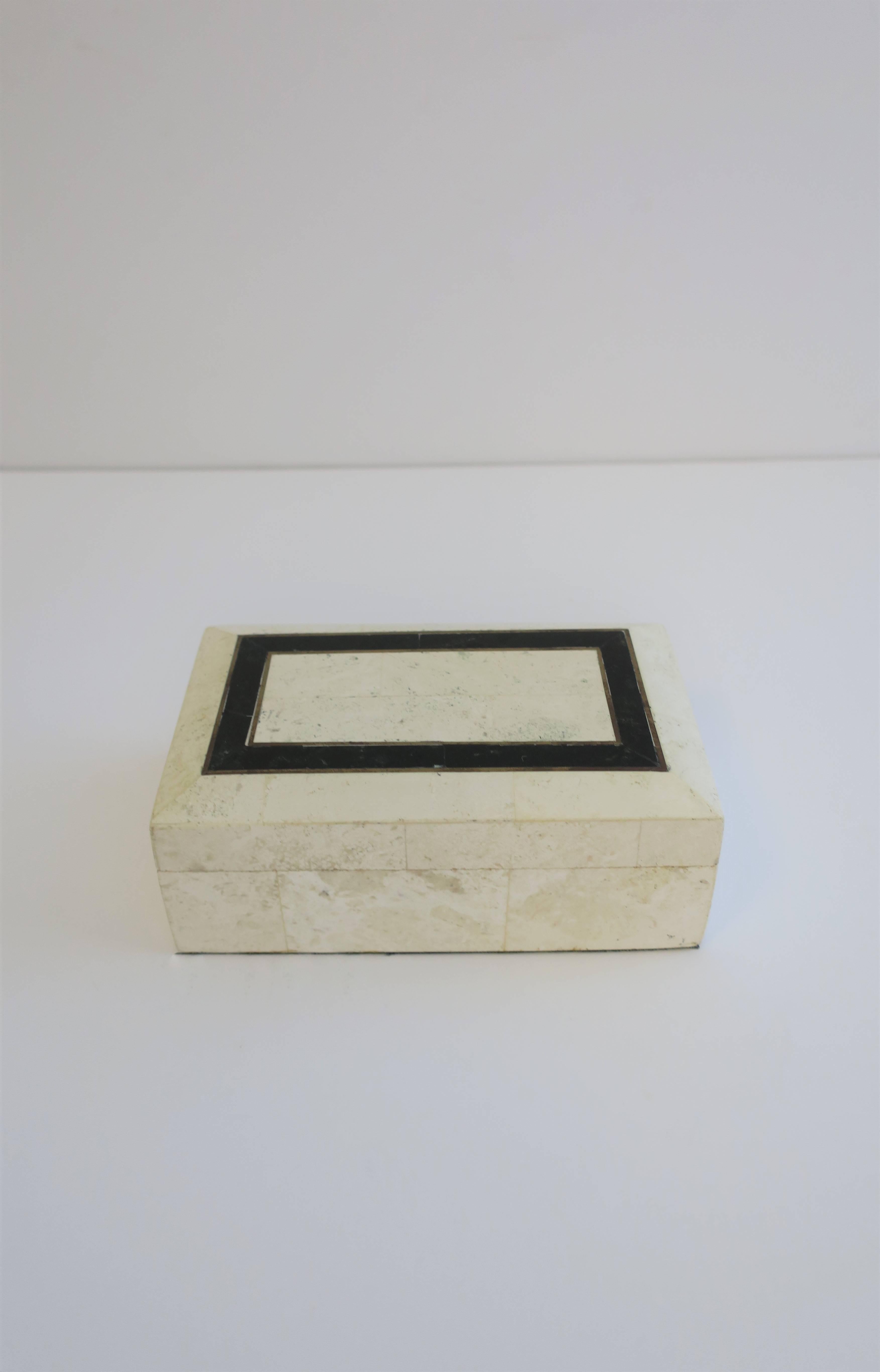 A beautiful Modern style black and white (white travertine marble is an off-white or cream hue) jewelry, vanity, or desk box with teak and velvet interior, circa late 20th Century, Post-Modern. Box lid has brass inlay detail between black stone and