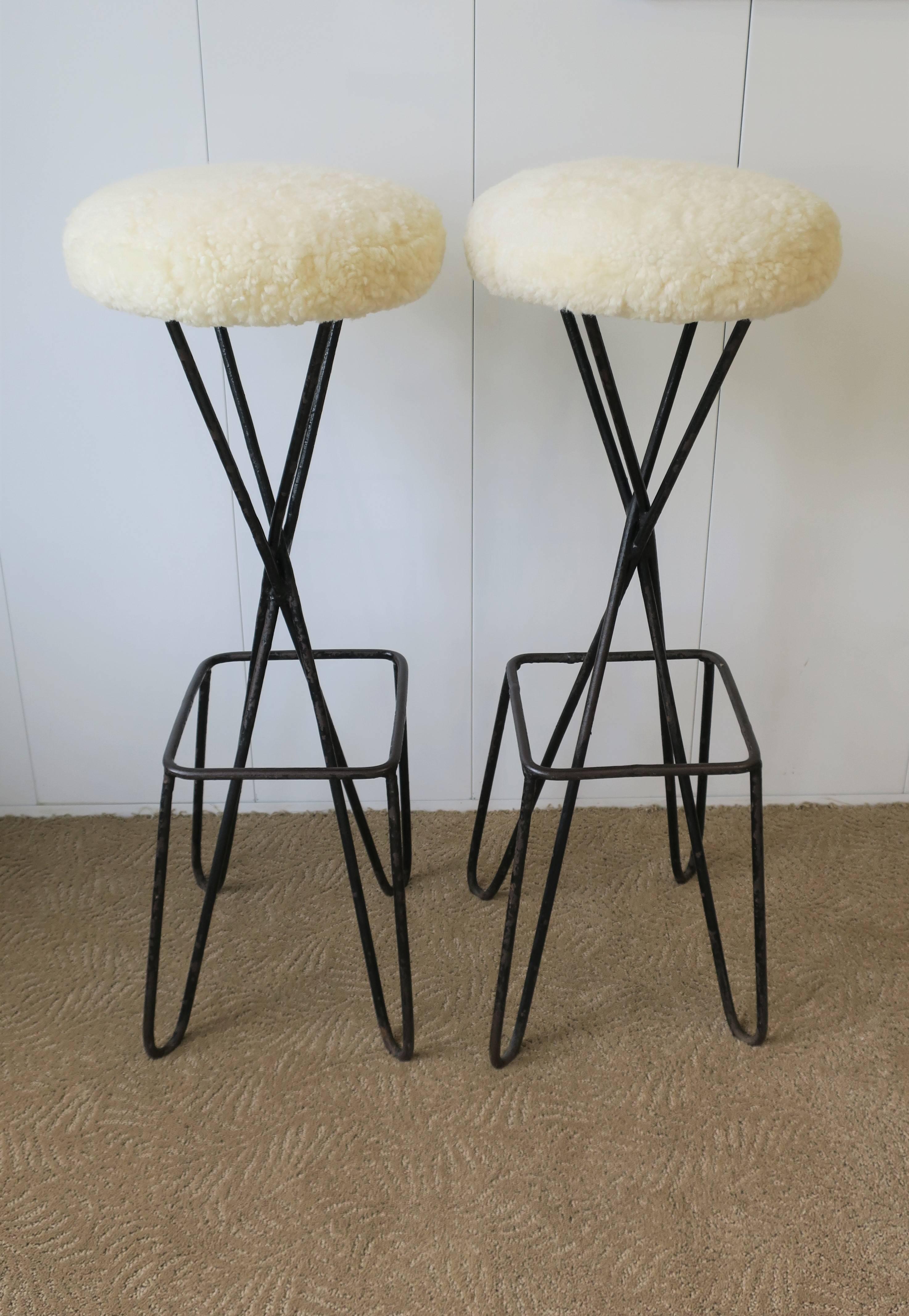 Pair/set available here for $3200
A pair of designer Frederick Weinbeg hairpin black enameled metal bar stools with sheepskin-esque upholstered seats, circa mid-20th century. This substantial pair of stools have newly re-upholstery sheepskin-esque