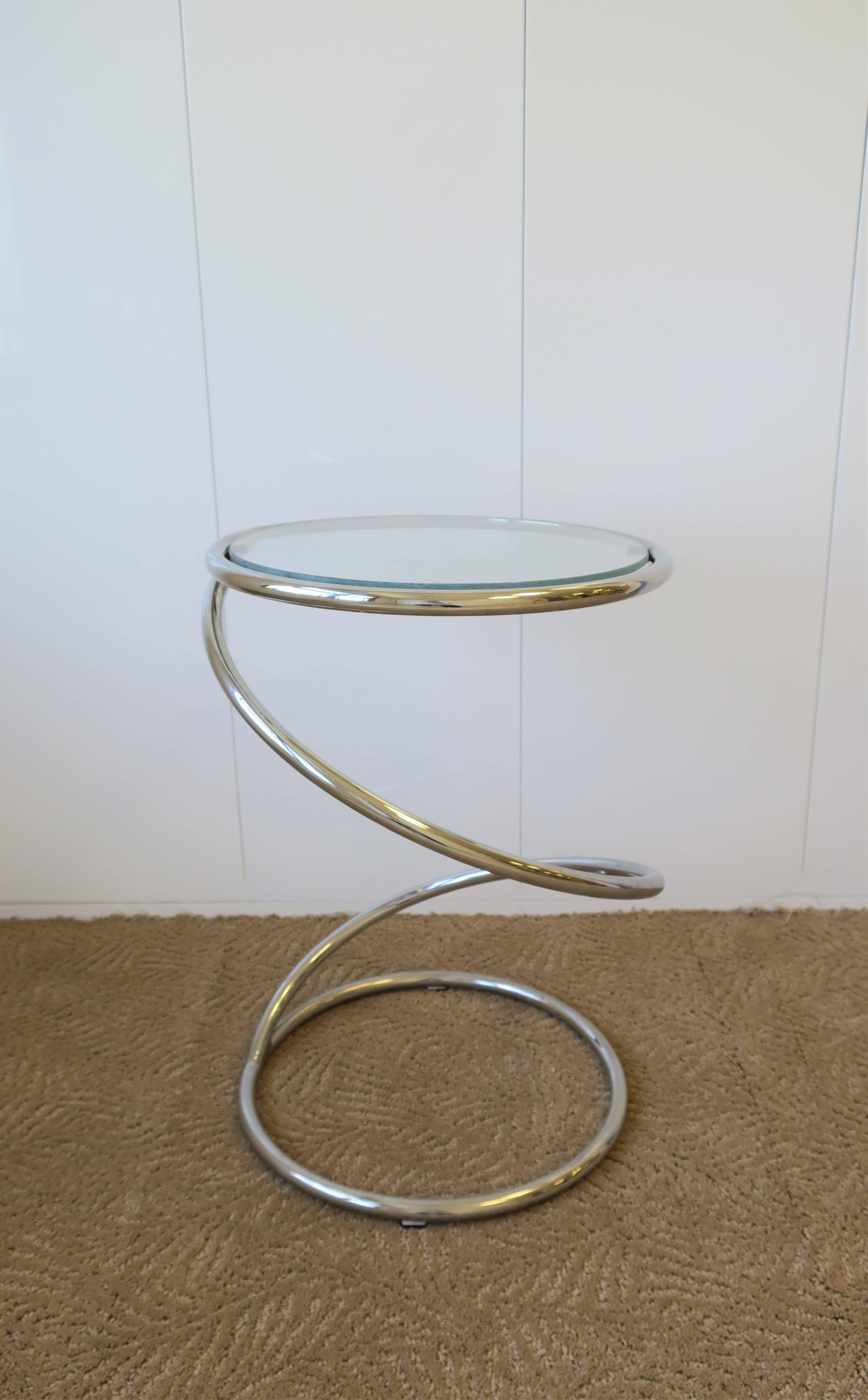 A vintage Modern round chrome and glass twist side table, circa 1970s Modern.  

Table measures: 19.25 in. H x 13.25 in. diameter

