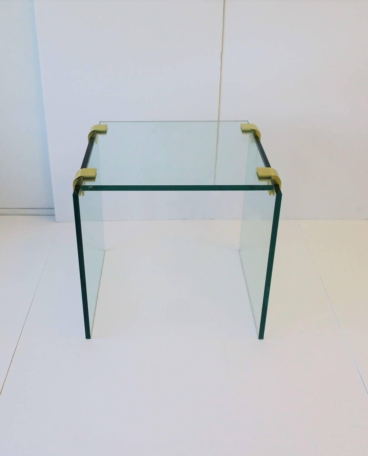 A substantial Modern or Minimalist style glass end or side table with brass fittings. Table is in the style of designer Leon Rosen for Pace Collection. 

Measures 15.75 in. H 

