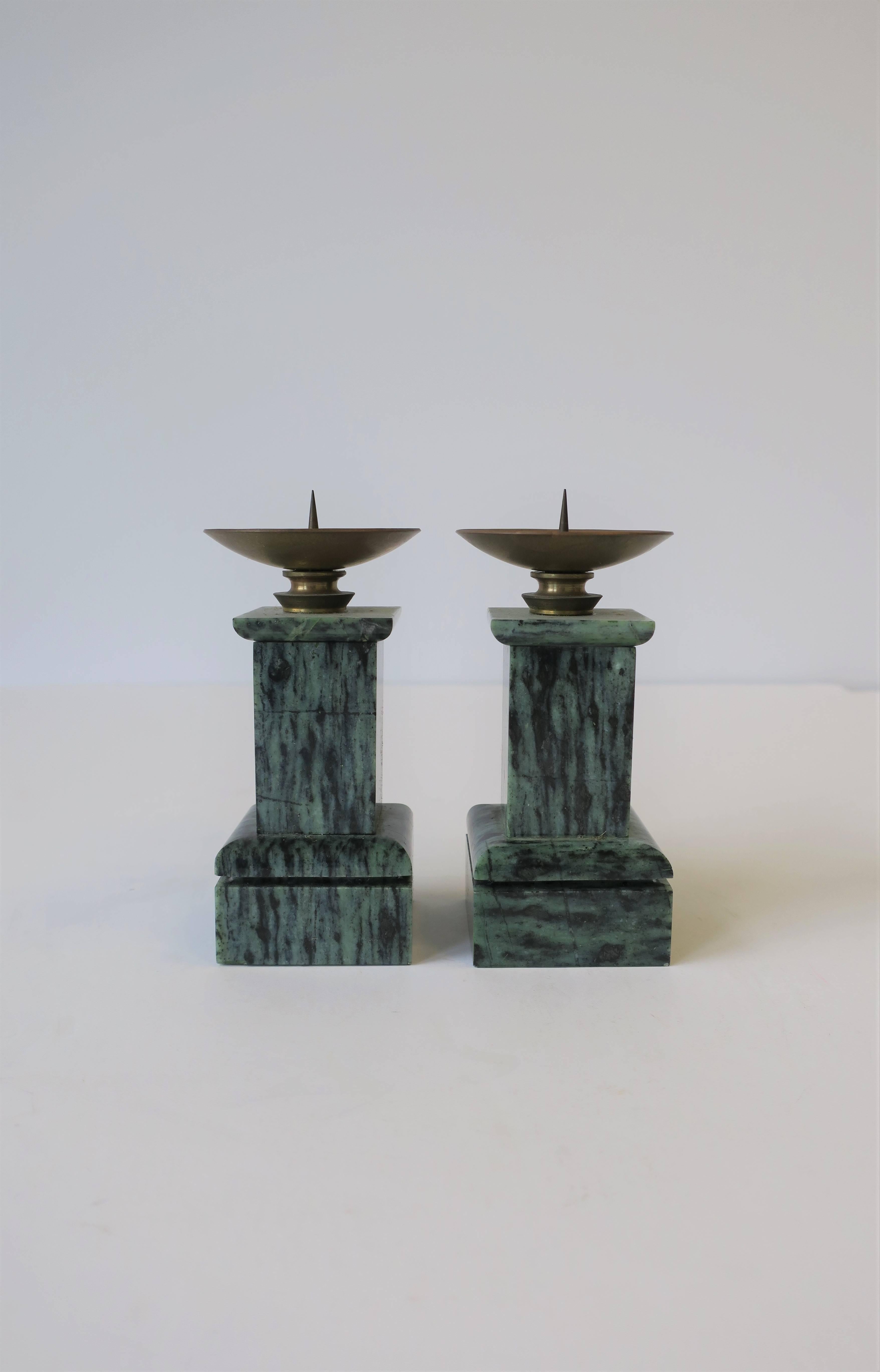 A beautiful pair of small well-made column pillar dark green and black marble candlestick holders with brass top, in the Neoclassical design style, circa mid-20th century. Candles shown in image #3 included with purchase. Very good condition as