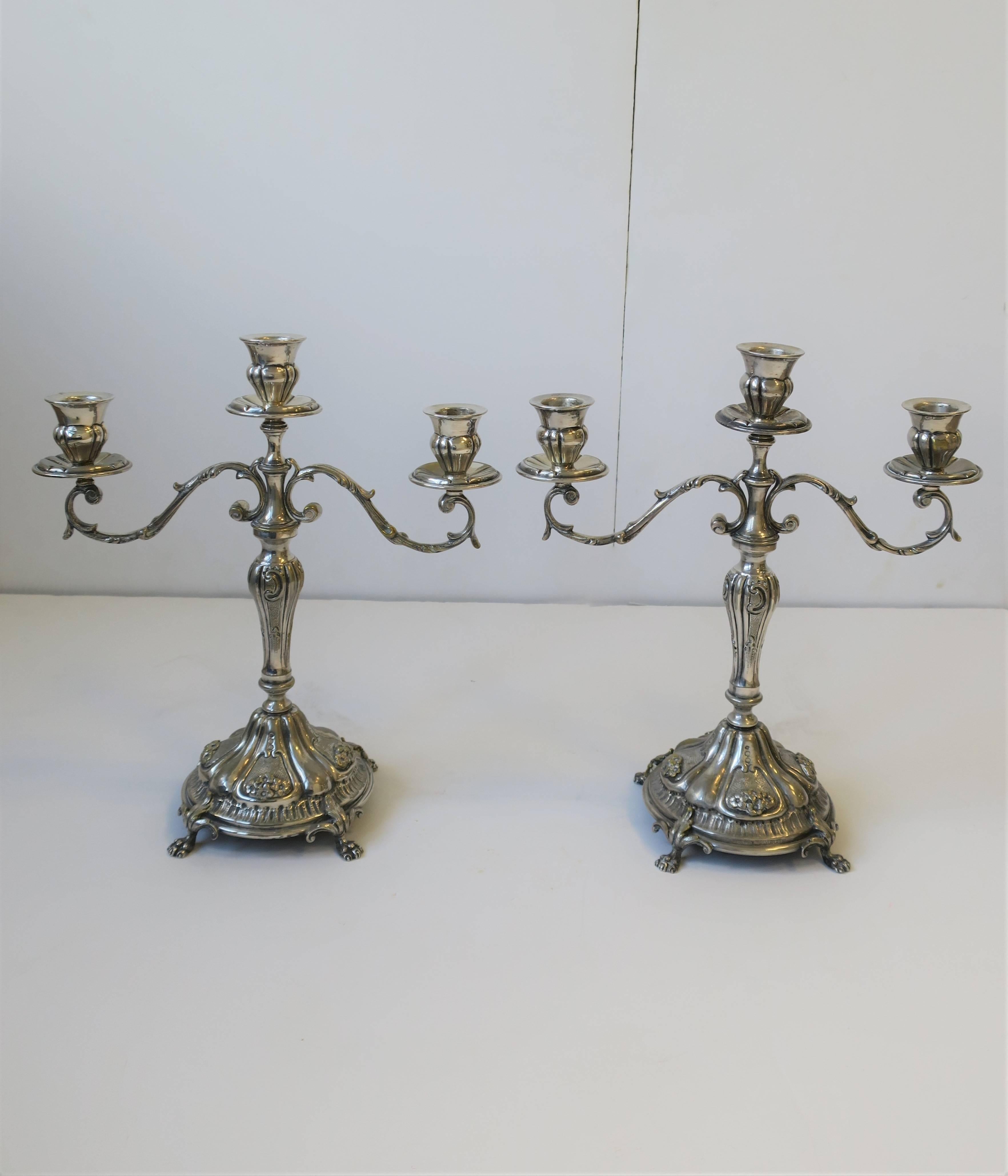A beautiful pair of Italian sterling silver-plated candlestick holders or candelabras, Italy, circa 20th century. Candlesticks are in the Regency style with beautiful details and paw feet. Pair are marked 