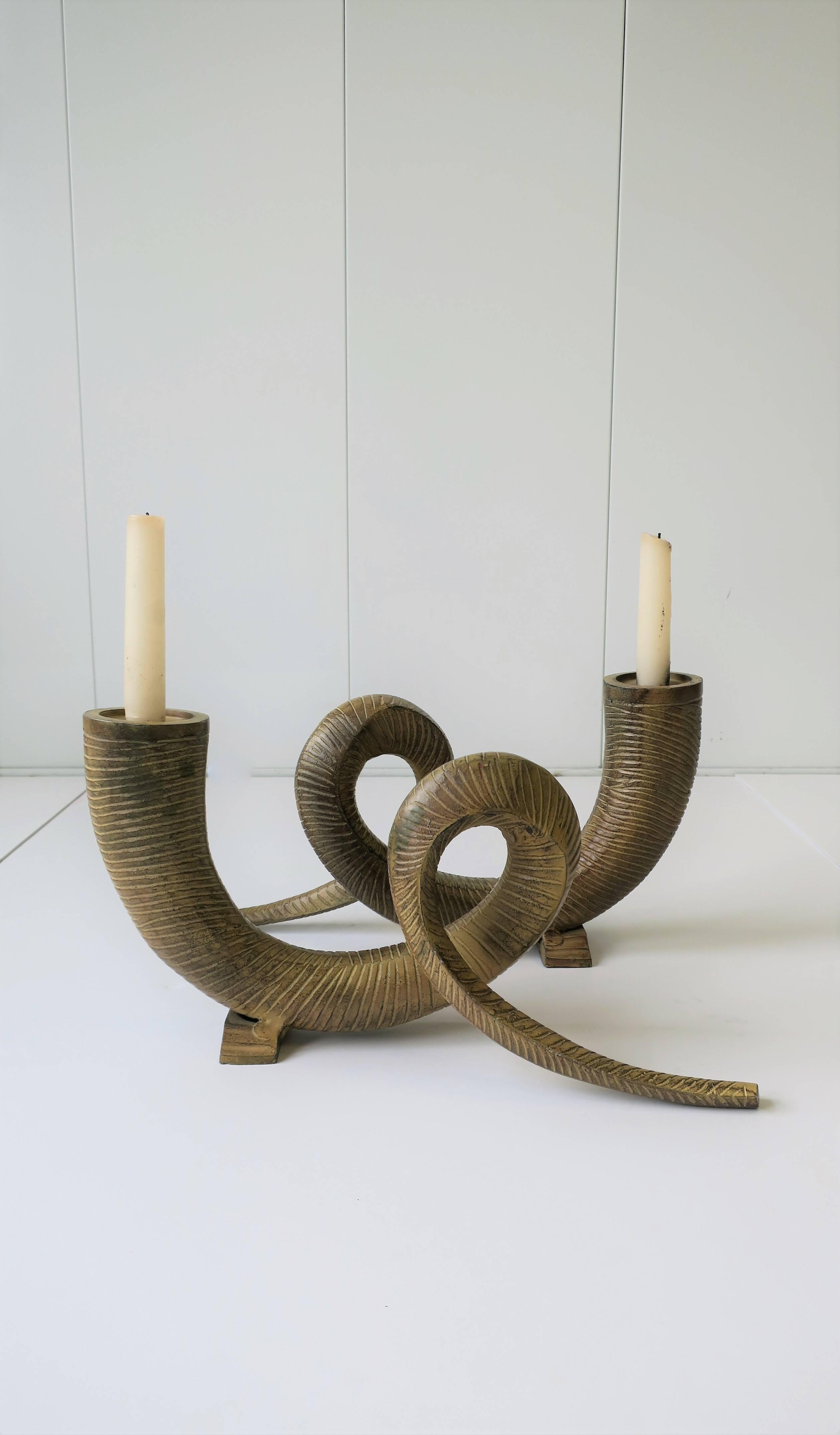 A pair of '80s Postmodern metal animal rams horn decorative sculptures or candlestick holders, circa 1980s. This pair of enameled metal ram horn candlesticks holders can also work great as standalone decorative objects as show in images. 

Each