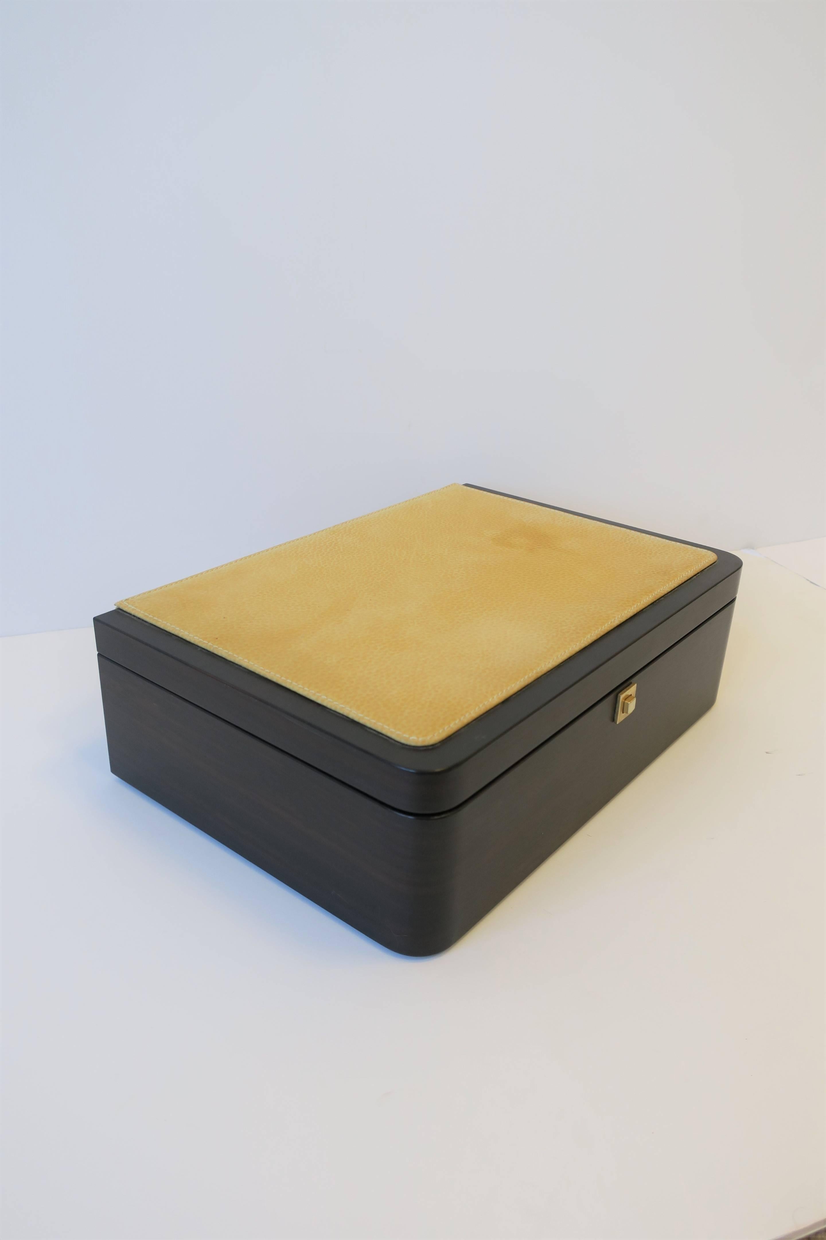 A beautiful Modern style Italian leather and wood jewelry box, circa early 21st century, Italy. Box has a wood and yellow leather exterior, and interior is upholstered in a supple butter yellow leather. Box has several compartments, including soft