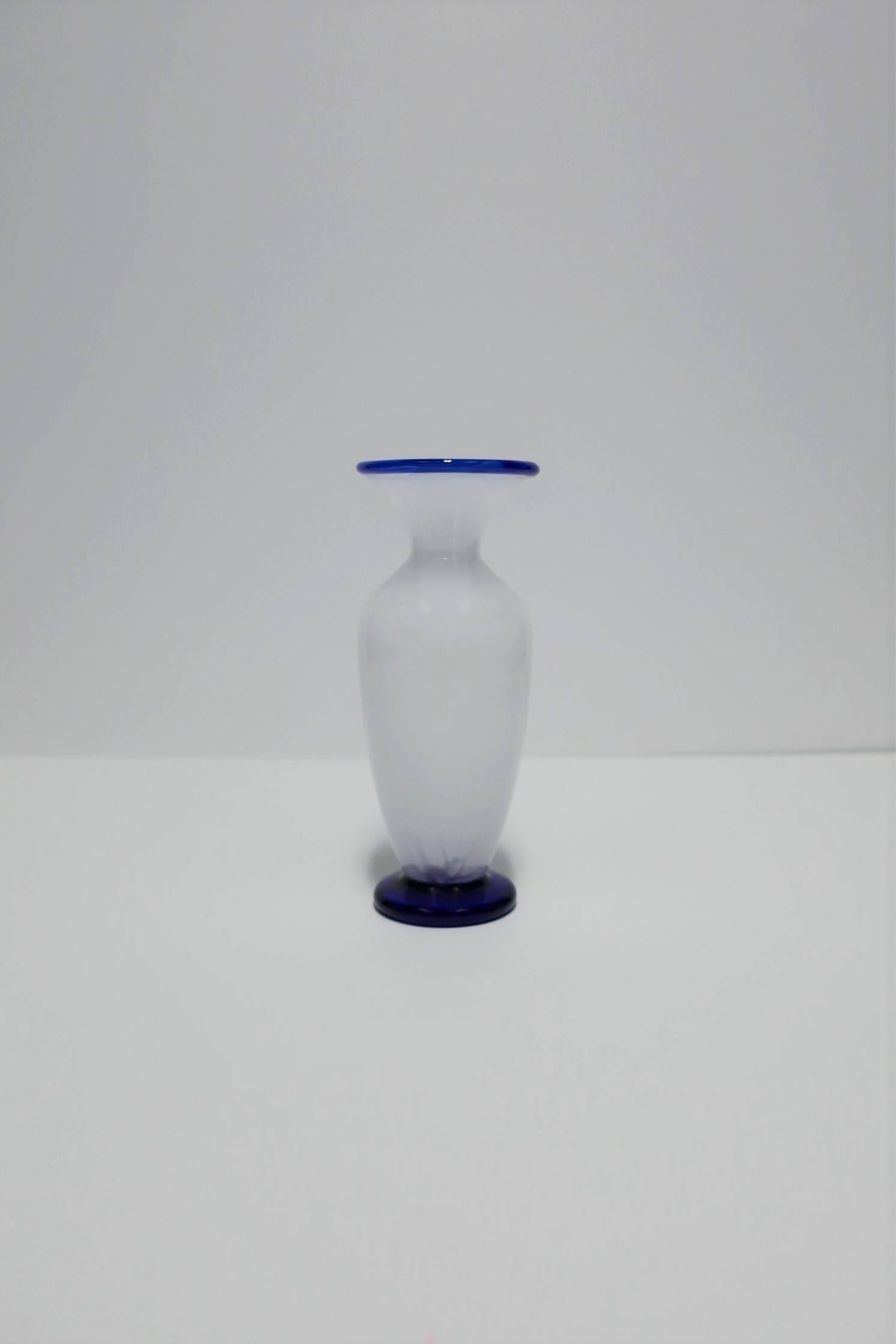 A beautiful and substantial Italian urn form blue and white art glass vase. Art glass is a beautiful combination of bright white and cobalt blue. Handblown as show from blowing tool mark on bottom (images #7 and #8.)

Vase measures: 2.25 in. D x 6.5