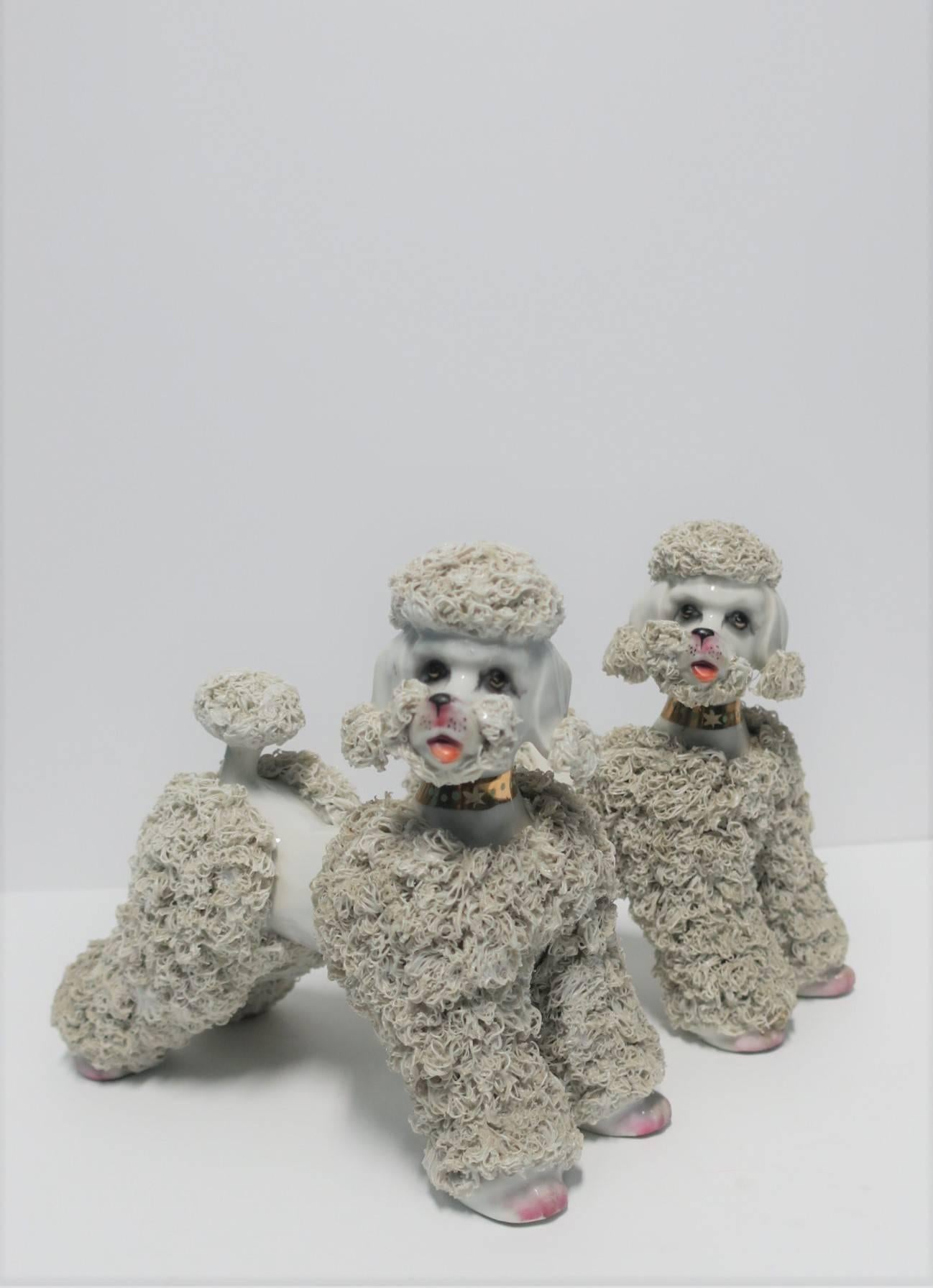 A relatively large pair of mid-20th century ceramic porcelain 'Spaghetti' Poodle Dog Sculptures. Poodle dog's have traditional poodle cut, stance, detailed face (eyes, nose, tongue), and gold collar. Each Poodle measures: 4