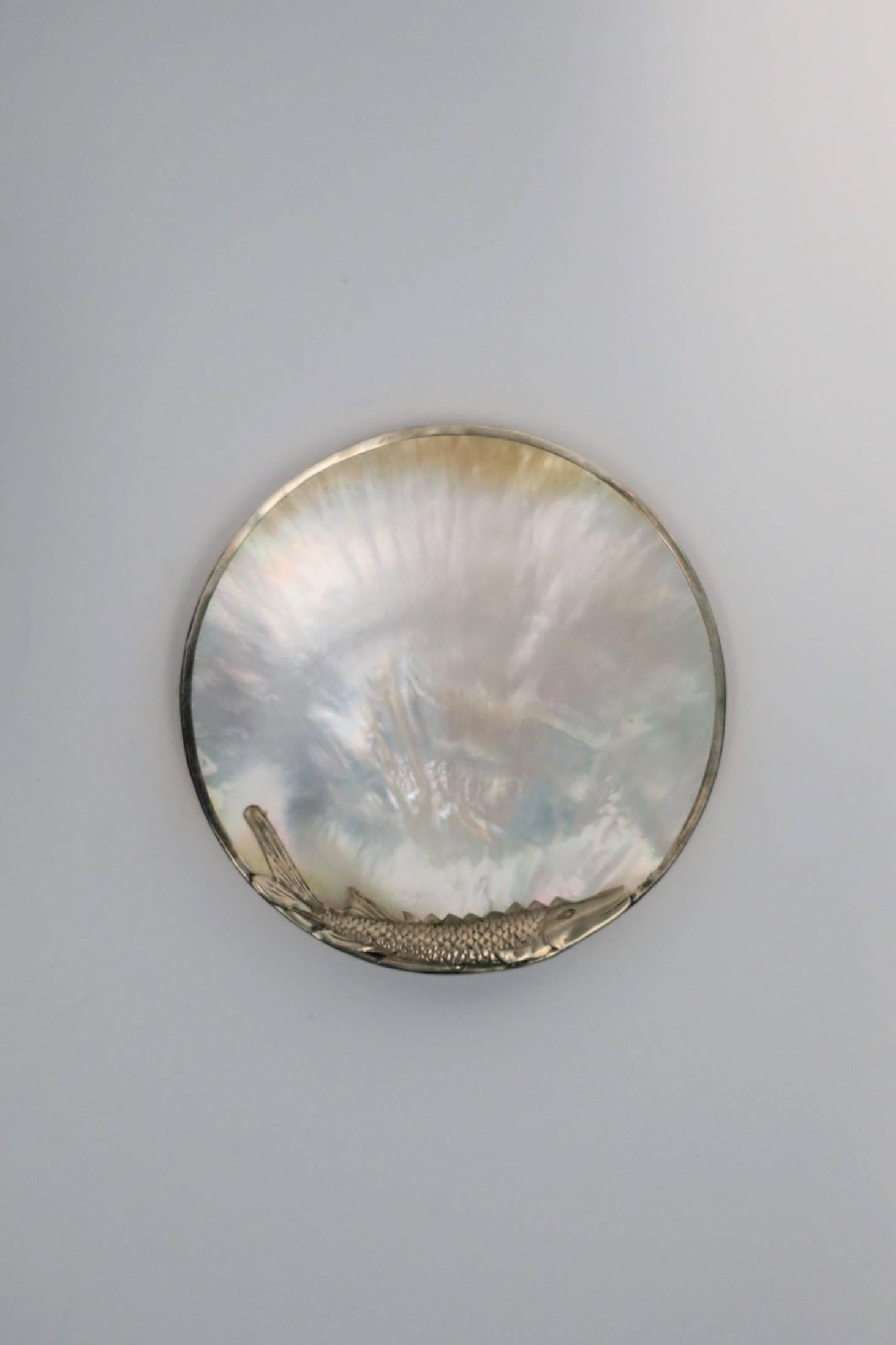 A beautiful vintage Mother-of-Pearl shell with decorative sturgeon fish caviar dish. 

Measures: 5 in. Diameter x 1 in. H

Complimentary front door delivery in New York (Manhattan.) 
Item available here online. By request, item can be made available