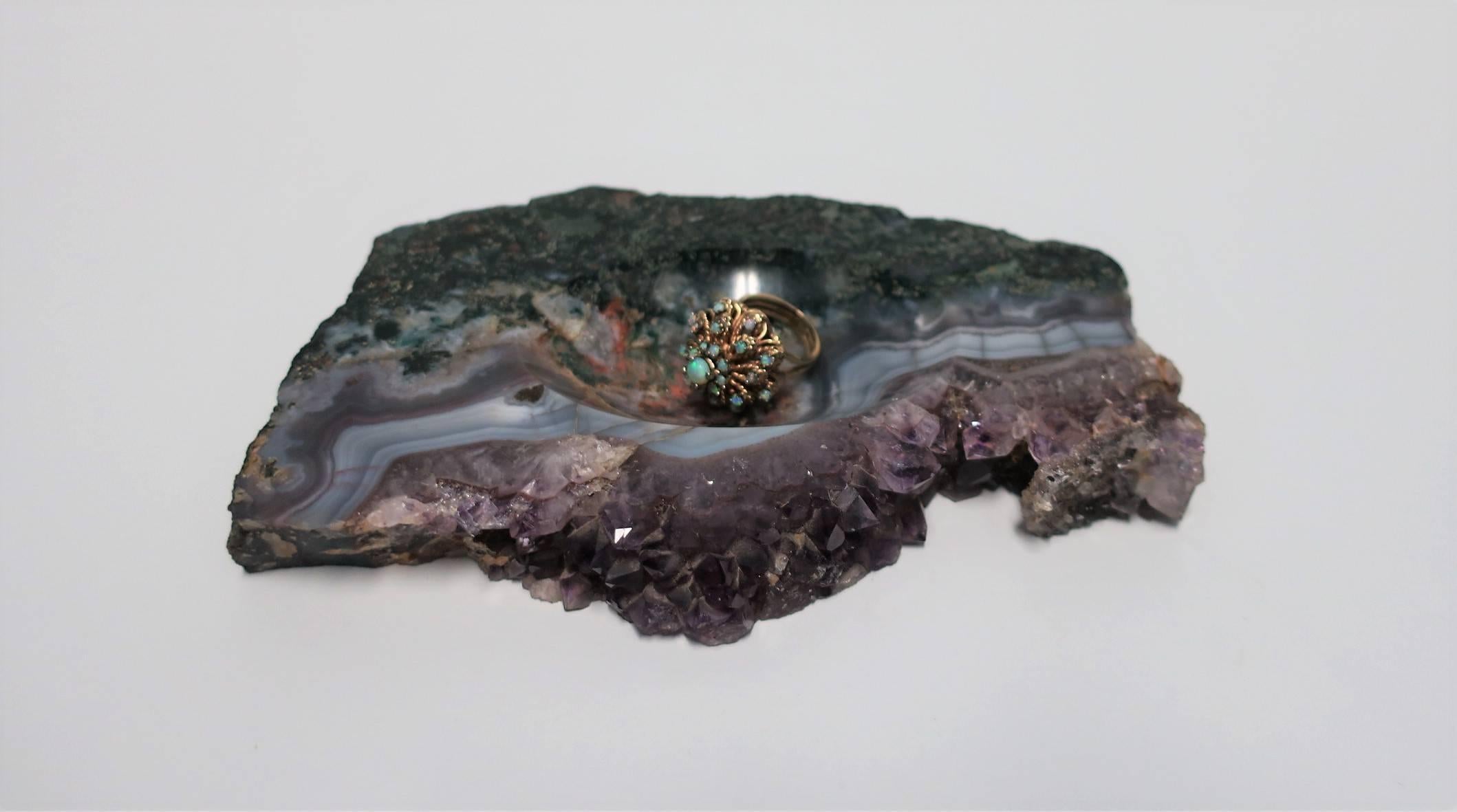 A beautiful natural purple amethyst geode vessel sculpture piece, or, as show in images, a jewelry or trinket dish. Piece can hold any small item(s), perhaps on a nightstand table, vanity, desk, or a standalone decorative object. Beautiful colors