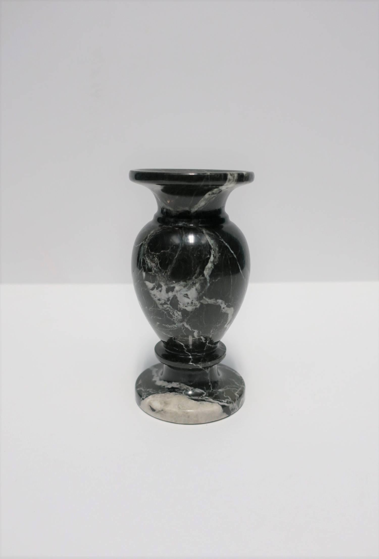 A beautiful and substantial black and white marble urn shaped vase, in the Neoclassical design style, circa mid-20th century. Vase is predominately black with white veining throughout, also known as Nero marble. Urn/vase measures: 3