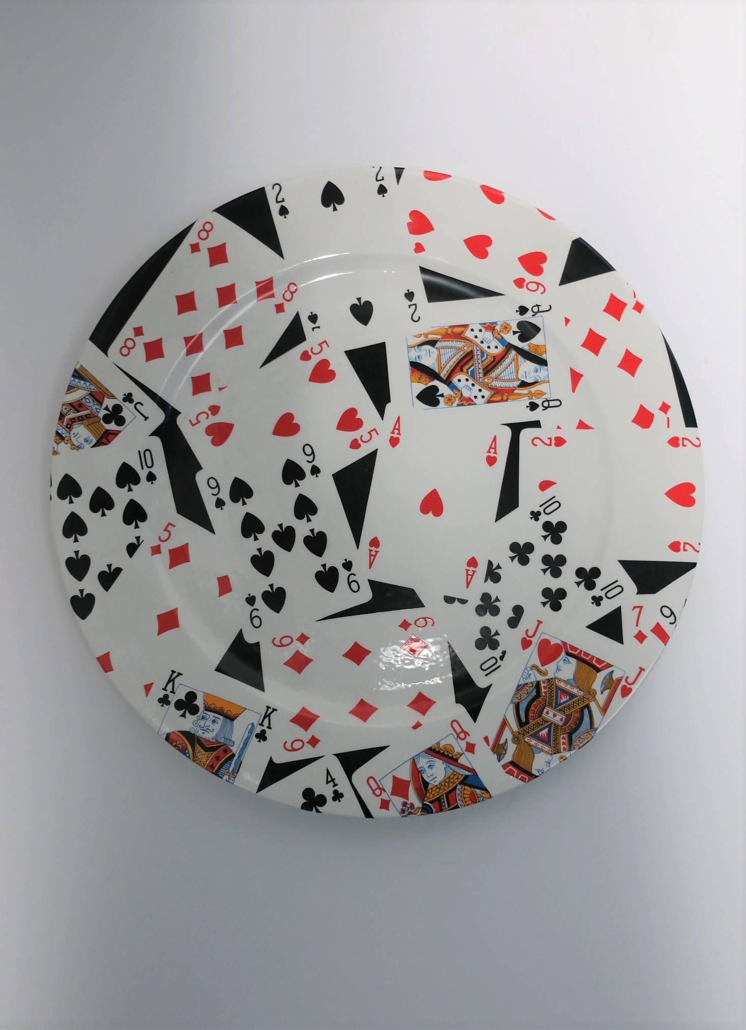 From luxury brand Gucci a ceramic plate with a 'suit' and 'face' playing card design, made in Italy by GUCCI. Plate can be used as a serving plate, or as a piece of art for display on a cocktail table or on the wall, etc. Plate measures: 12.5