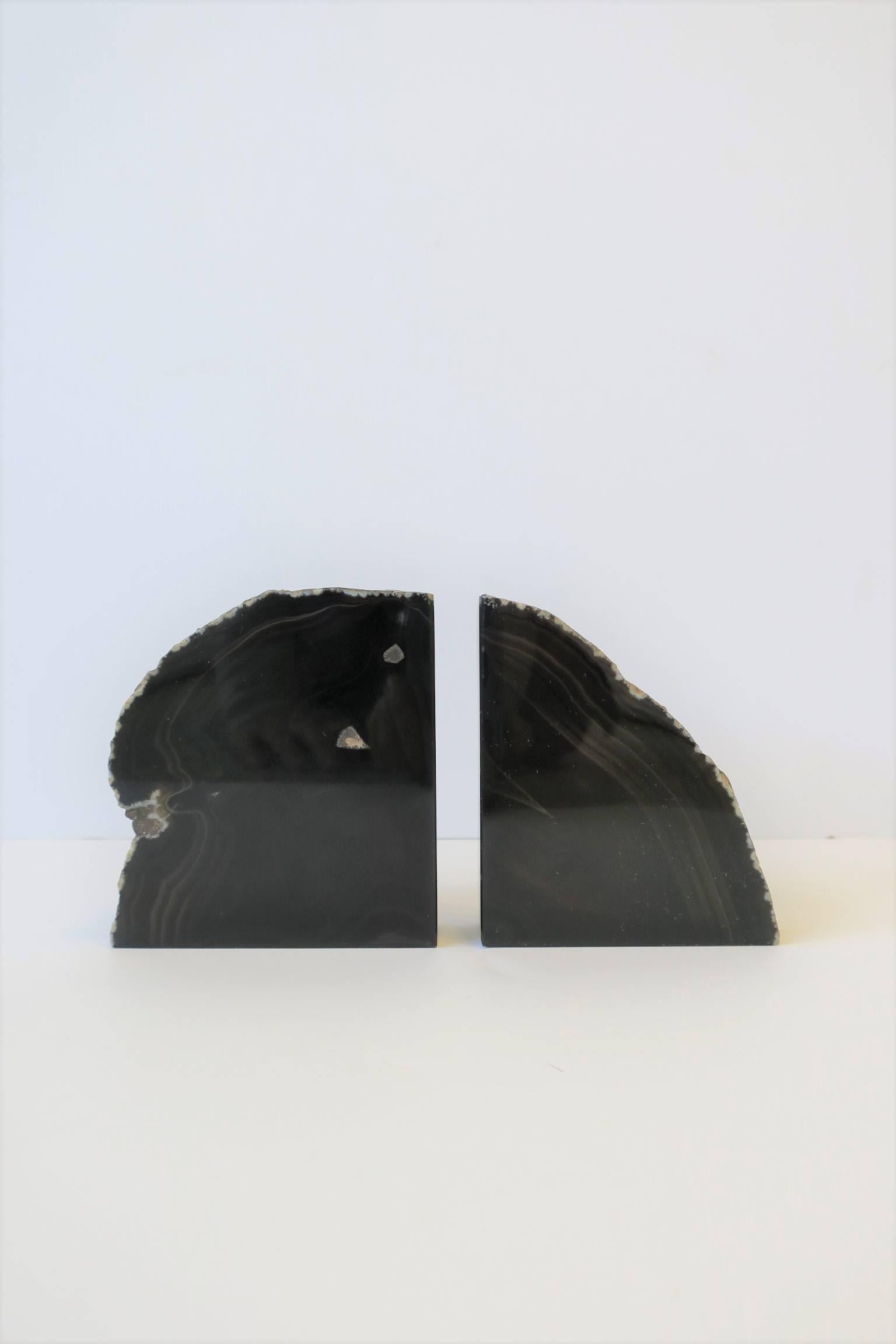 A pair of dark brown agate onyx bookends or decorative objects. 

Each measure: 3.25 in. W x 4 in. H

