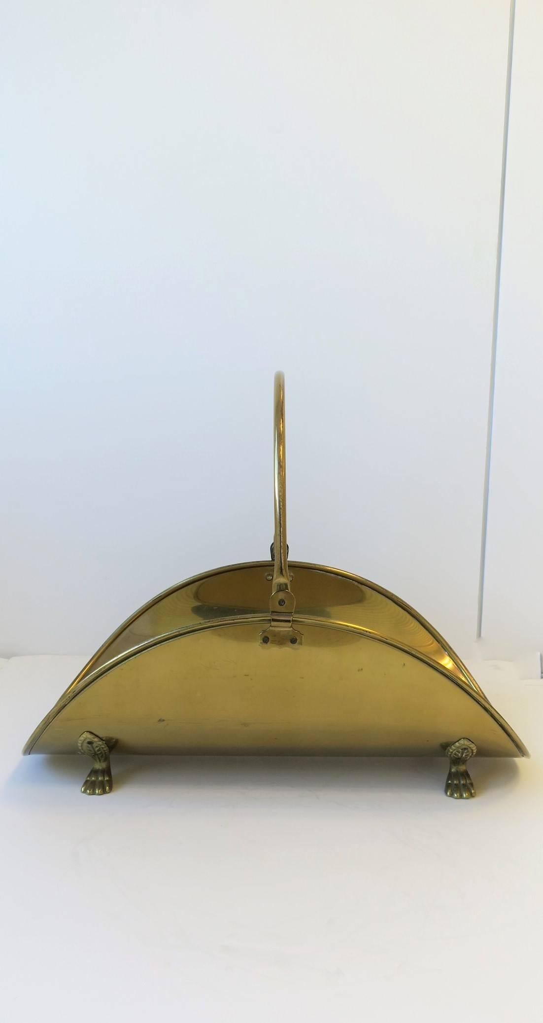 A vintage Regency style brass fire wood log holder with paw feet. 

Piece measures: 
17 in. H to top of Handle x 22 in. D x 12.5 in. W
8 in. H to top of Basket x 22 in. D x 12.5 in. W

Item available here online. By request, item can be made
